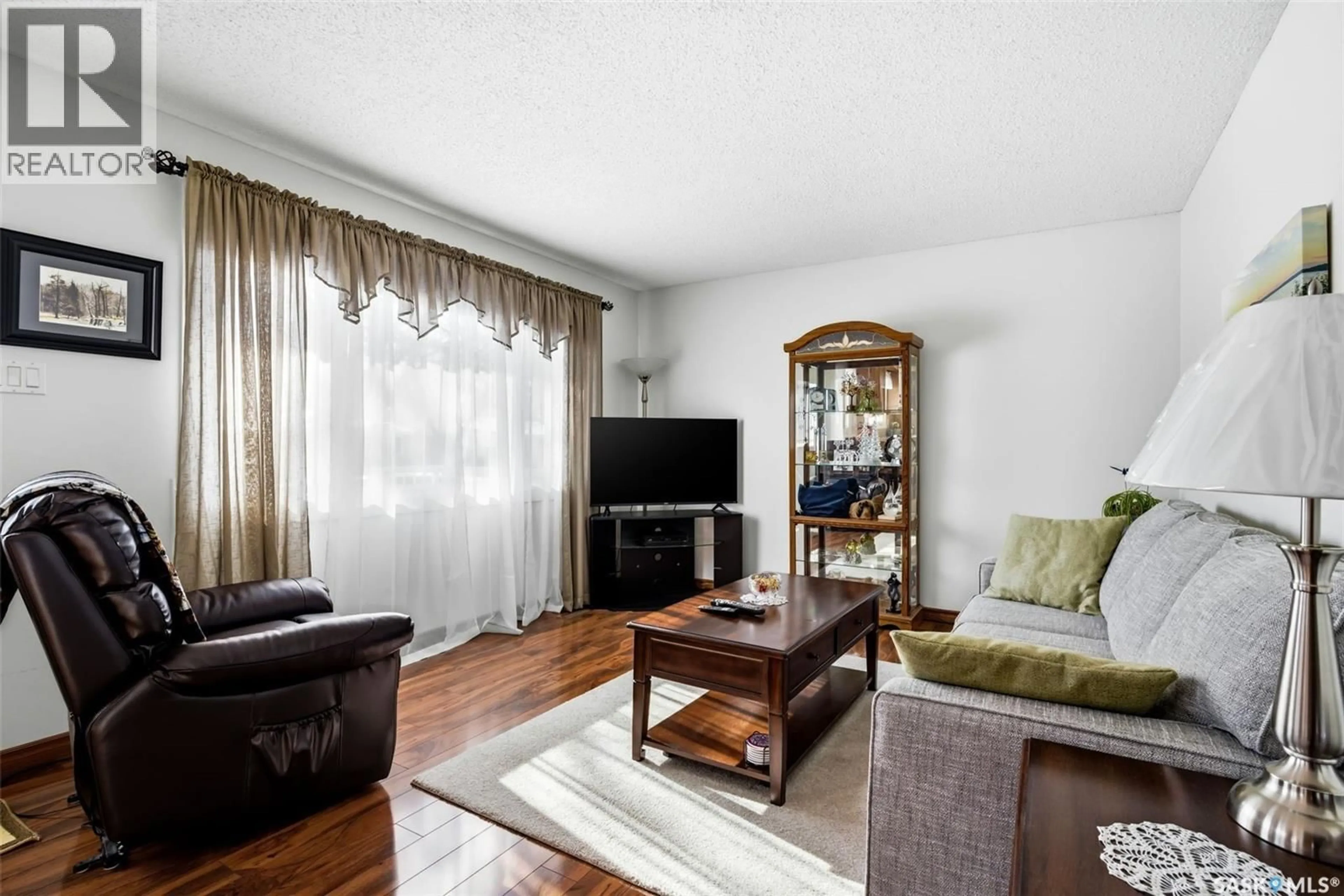 Living room with furniture, wood/laminate floor for 130 CHURCH DRIVE, Regina Saskatchewan S4X1P8