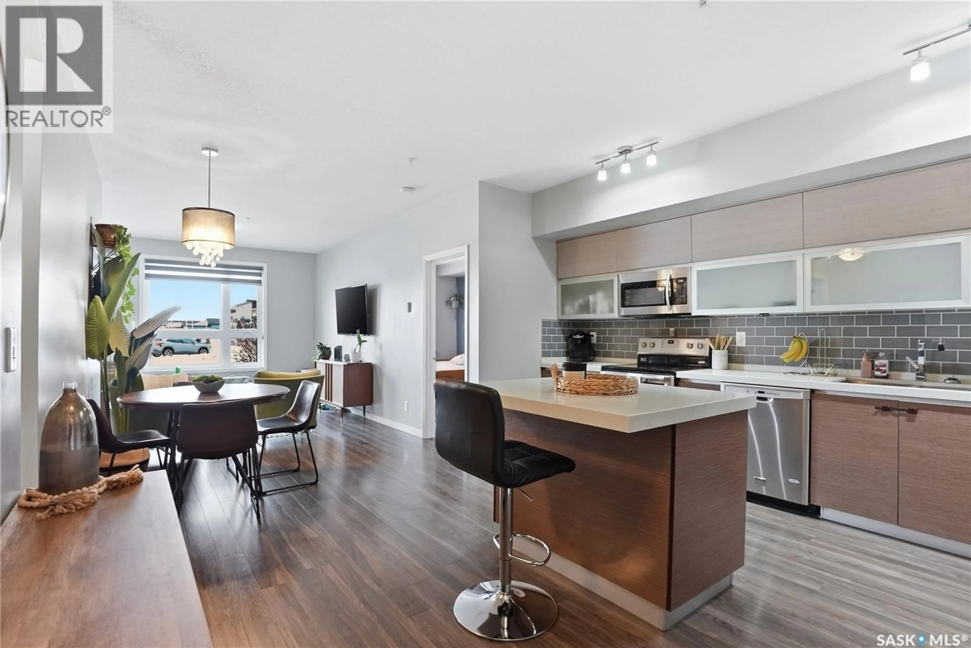 Open concept kitchen, wood/laminate floor for 102 235 EVERGREEN SQUARE, Saskatoon Saskatchewan S7W0T9
