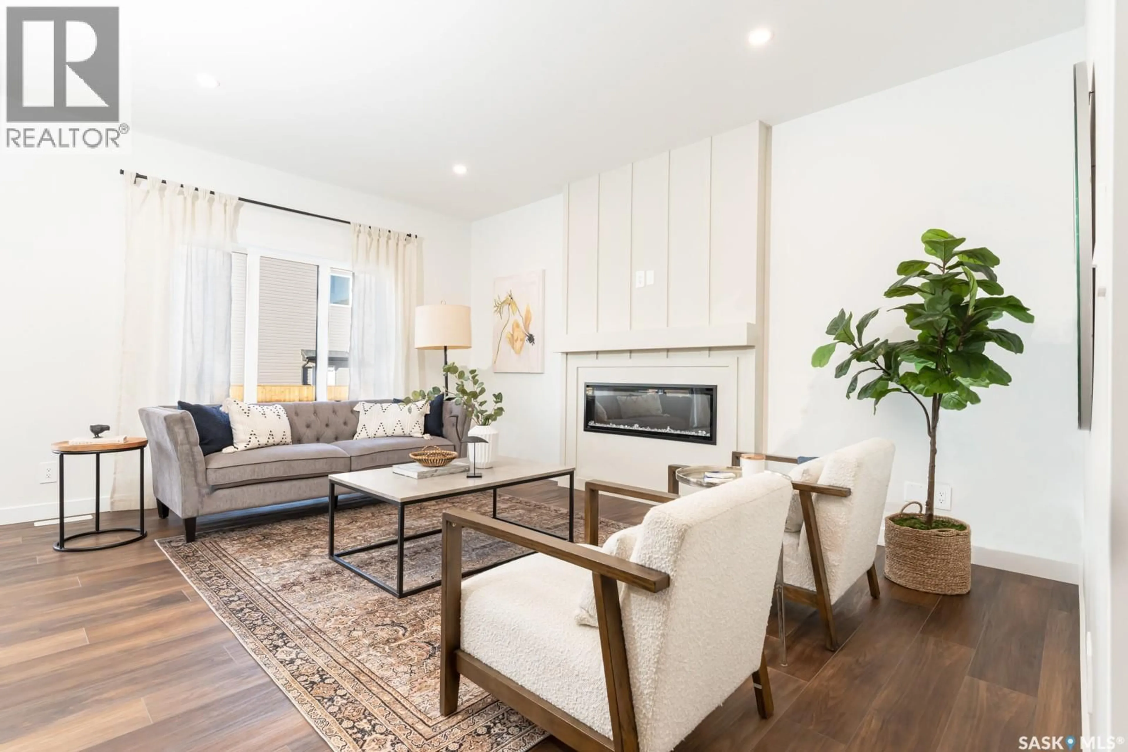 Living room with furniture, wood/laminate floor for 210 DORAN WAY, Saskatoon Saskatchewan S7N4V6