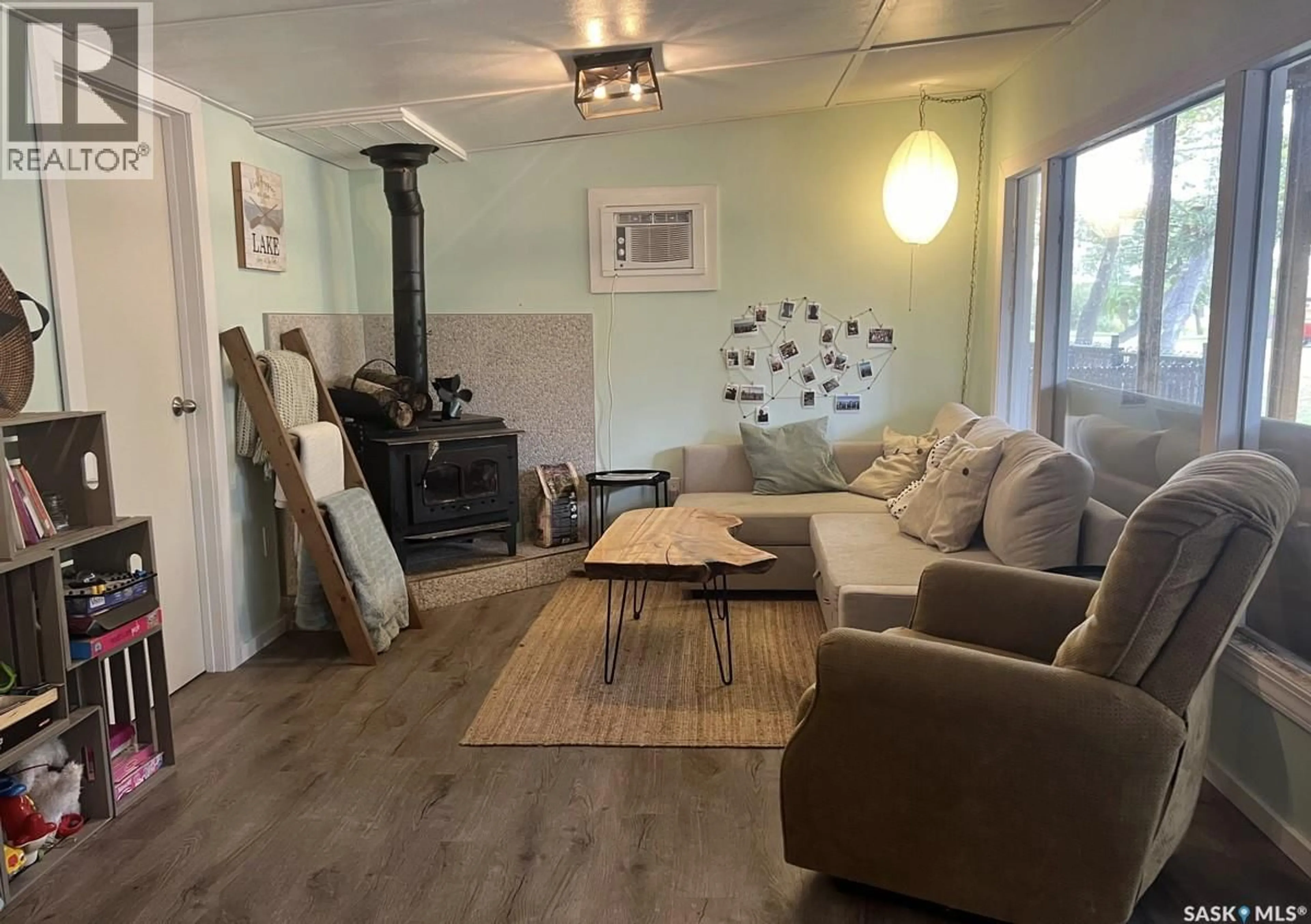 Living room with furniture, wood/laminate floor for 341 MARINER AVENUE, Aquadeo Saskatchewan S0M0L0