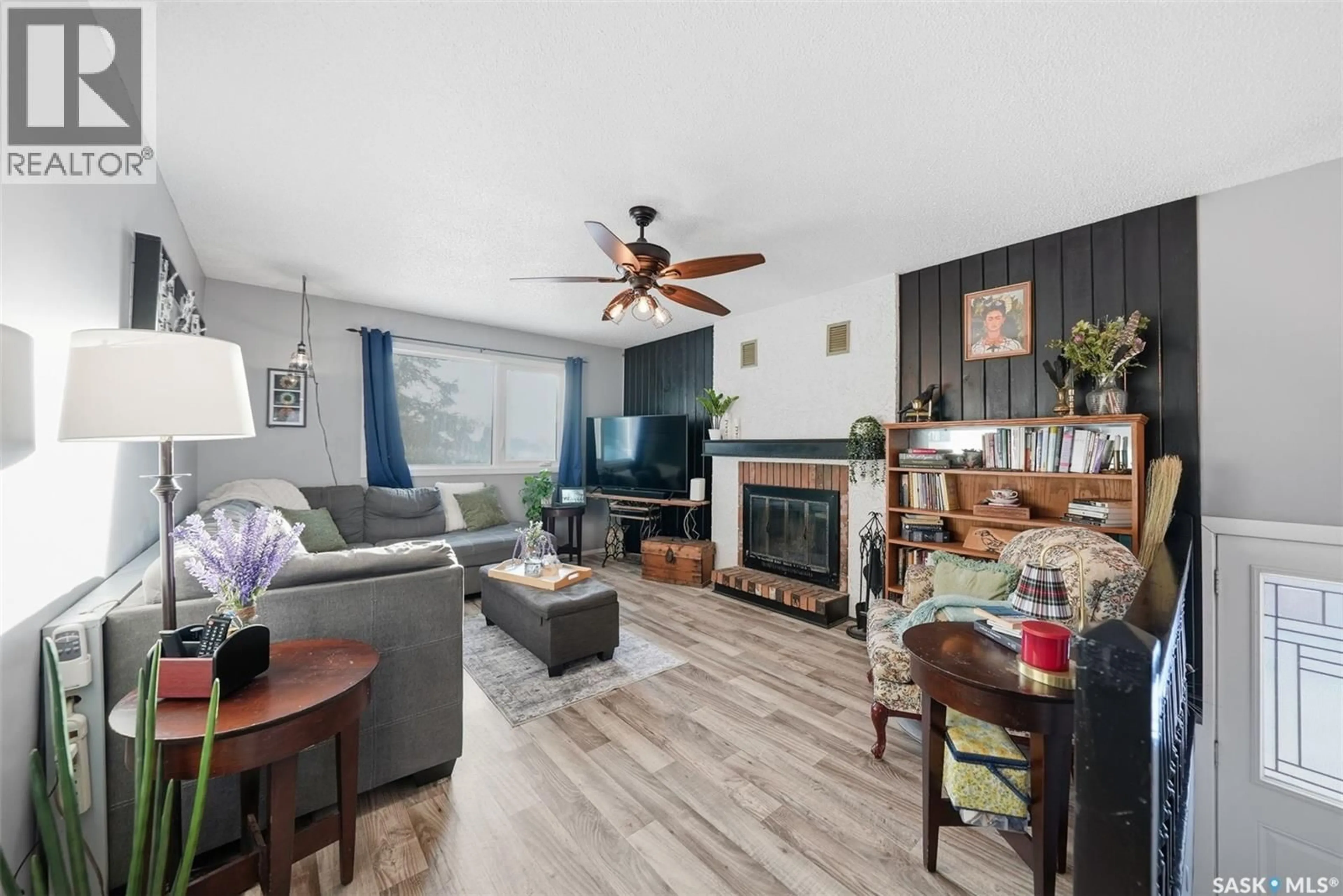 Living room with furniture, wood/laminate floor for 42 MACDOWALL CRESCENT, Prince Albert Saskatchewan S6V6N3