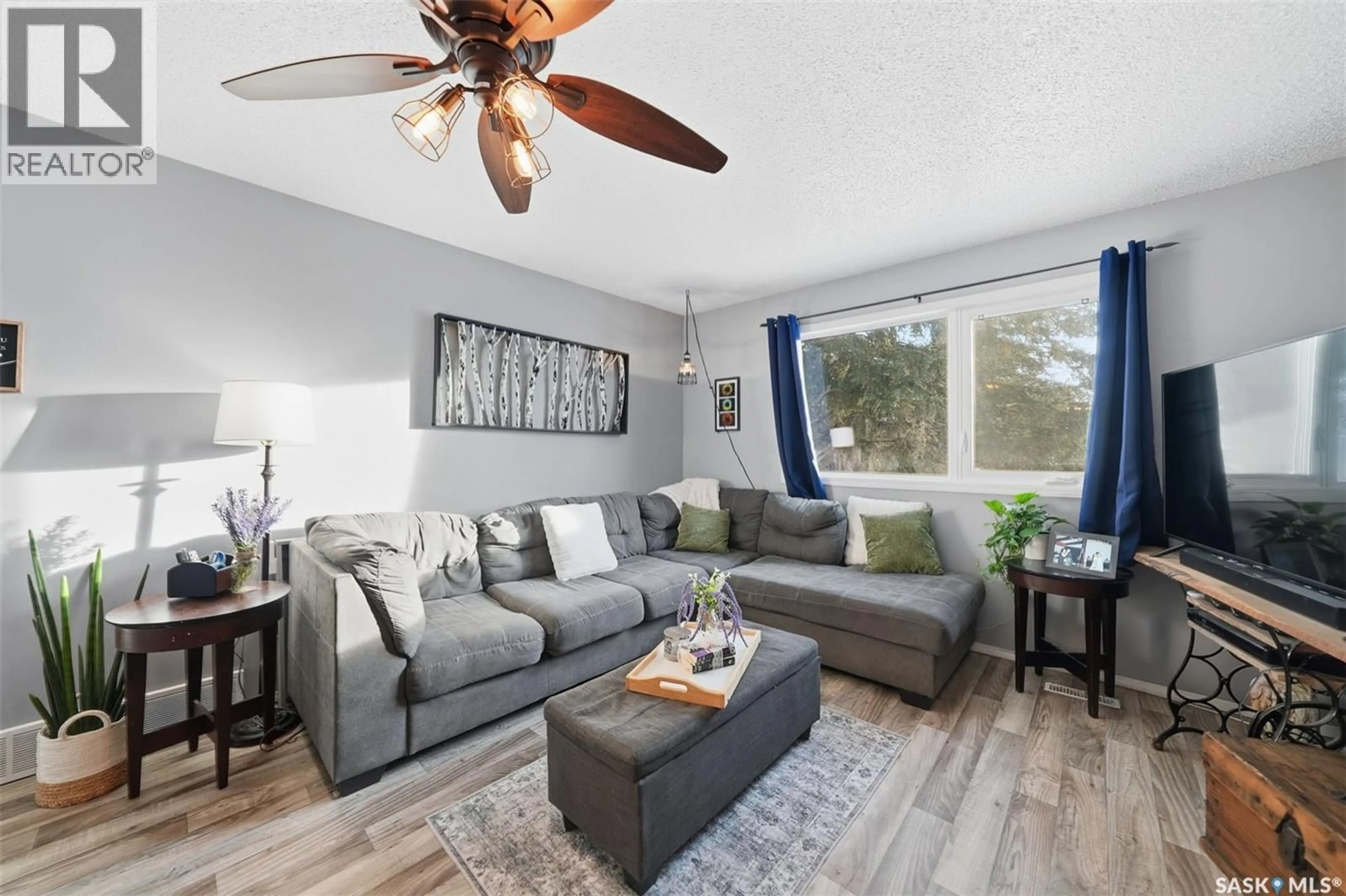 Living room with furniture, wood/laminate floor for 42 MACDOWALL CRESCENT, Prince Albert Saskatchewan S6V6N3