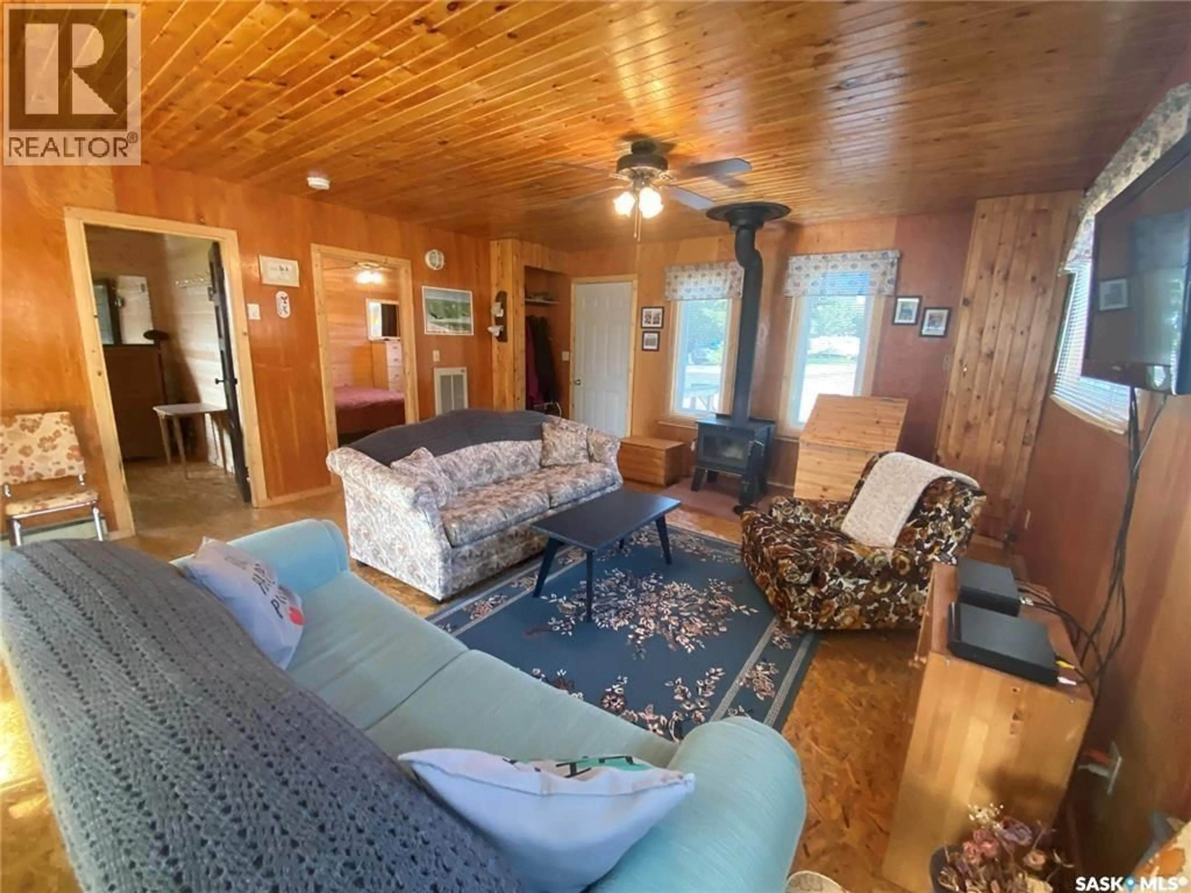 Living room with furniture, wood/laminate floor for 11 NORLAND PLACE, Candle Lake Saskatchewan S0J3E0