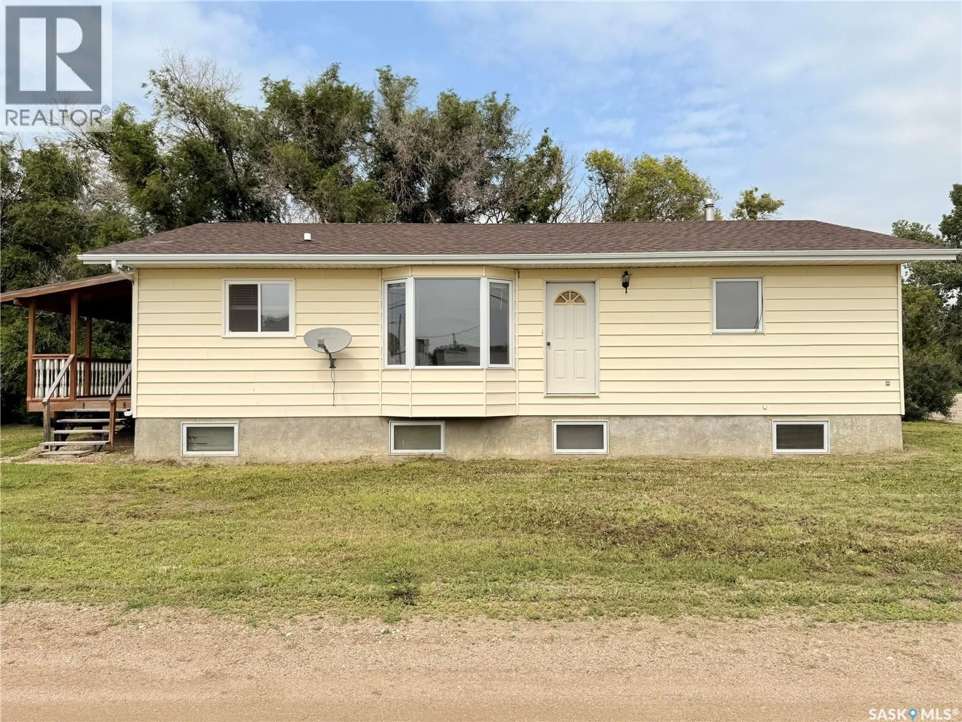 Home with vinyl exterior material, street for 100 1ST AVENUE, Lucky Lake Saskatchewan S0L1Z0