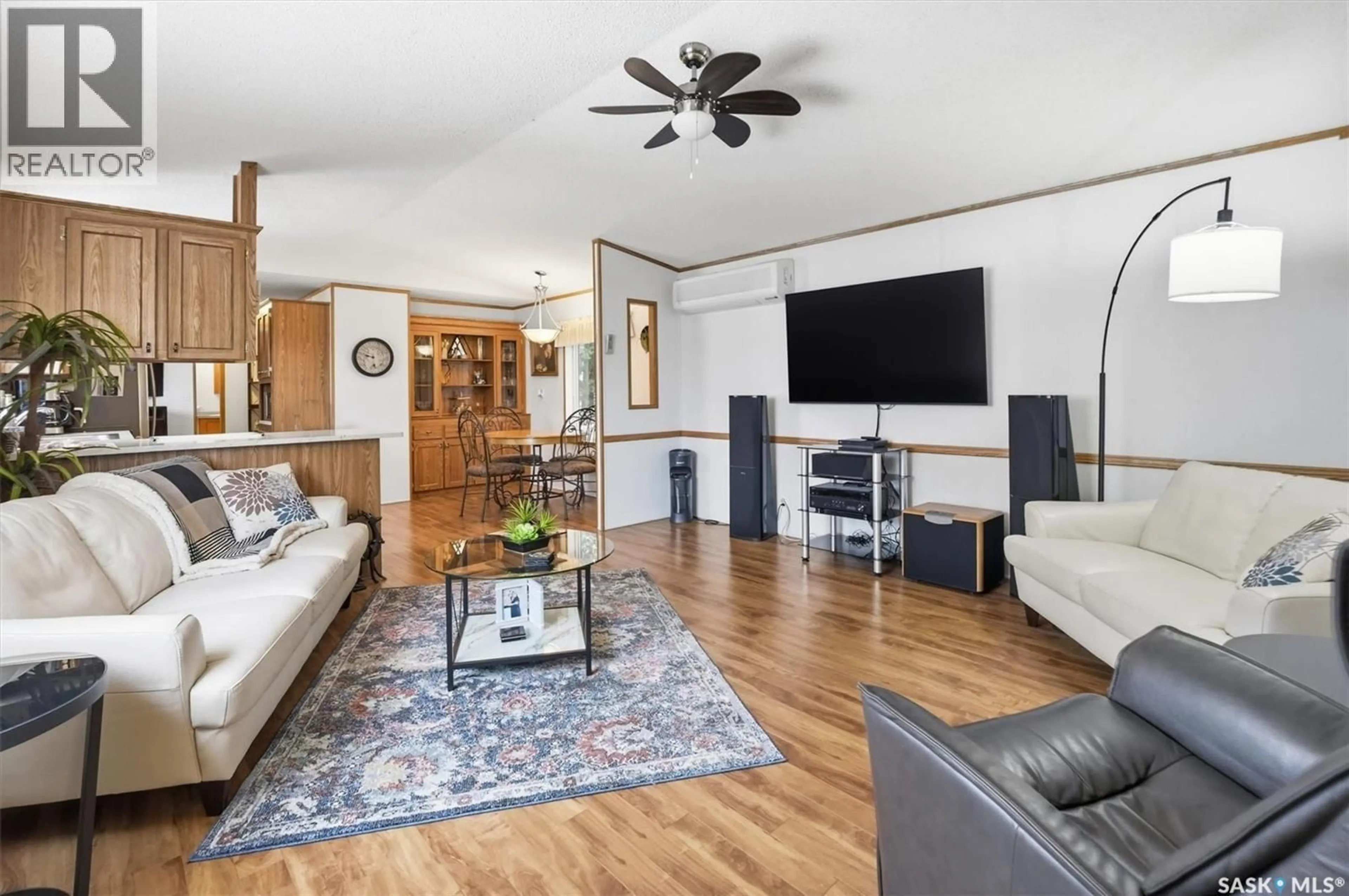 Living room with furniture, wood/laminate floor for 106 LOCHRIE CRESCENT, Saskatoon Saskatchewan S7M5E4