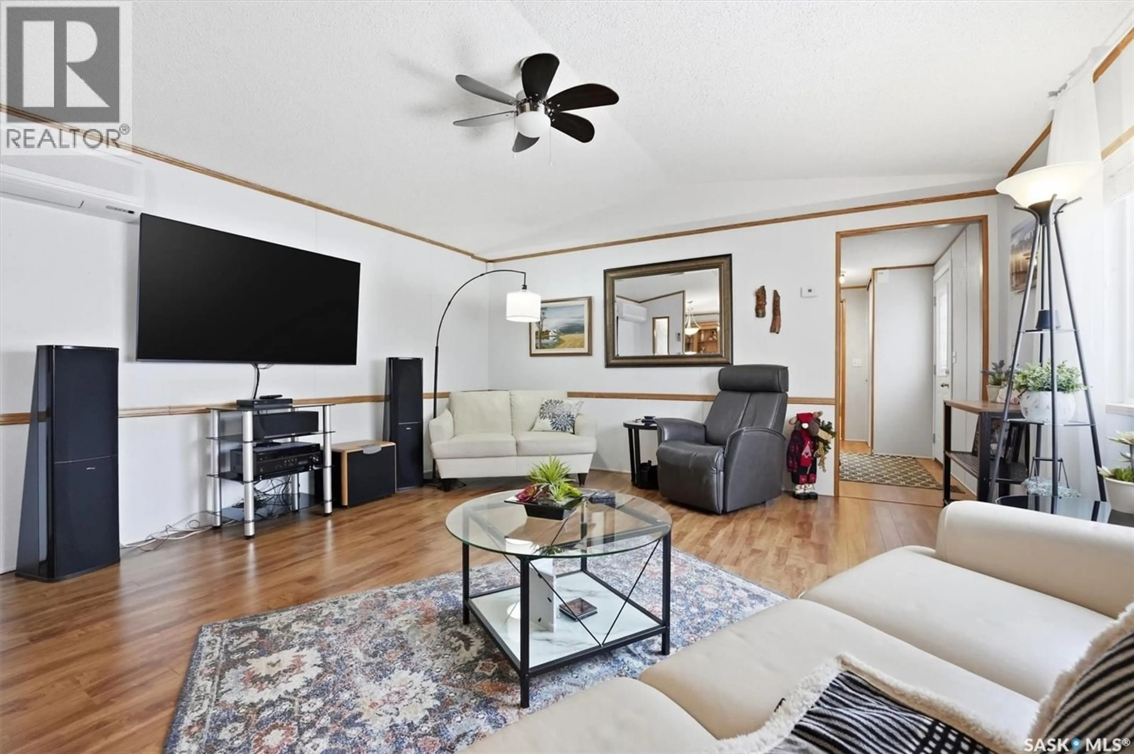 Living room with furniture, wood/laminate floor for 106 LOCHRIE CRESCENT, Saskatoon Saskatchewan S7M5E4