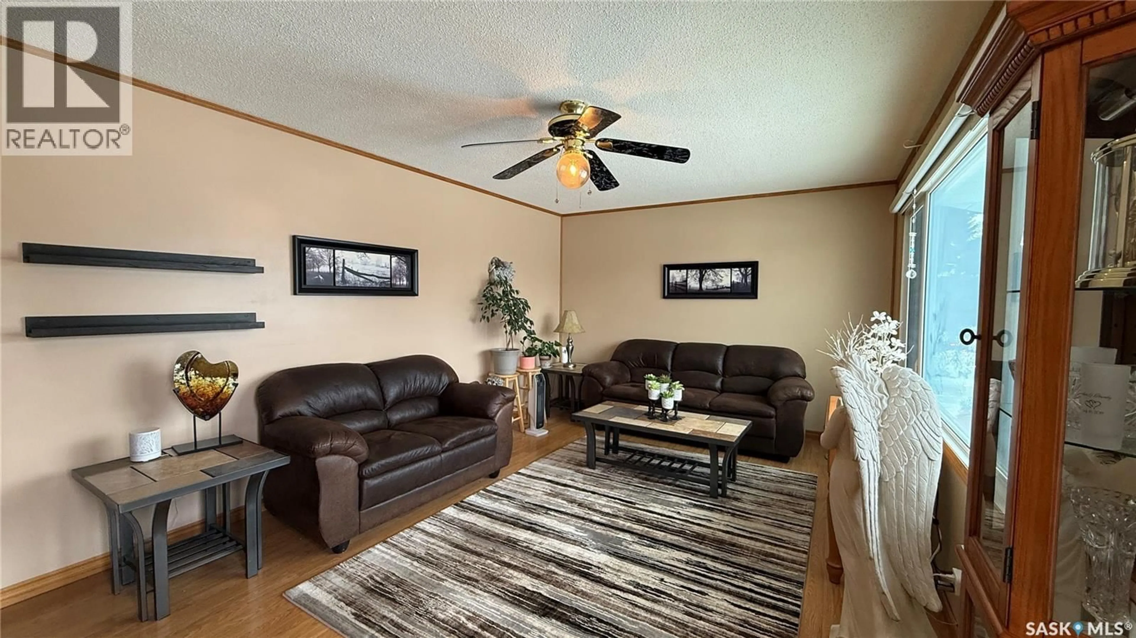 Living room with furniture, wood/laminate floor for 1742 105TH STREET, North Battleford Saskatchewan S9A1V1