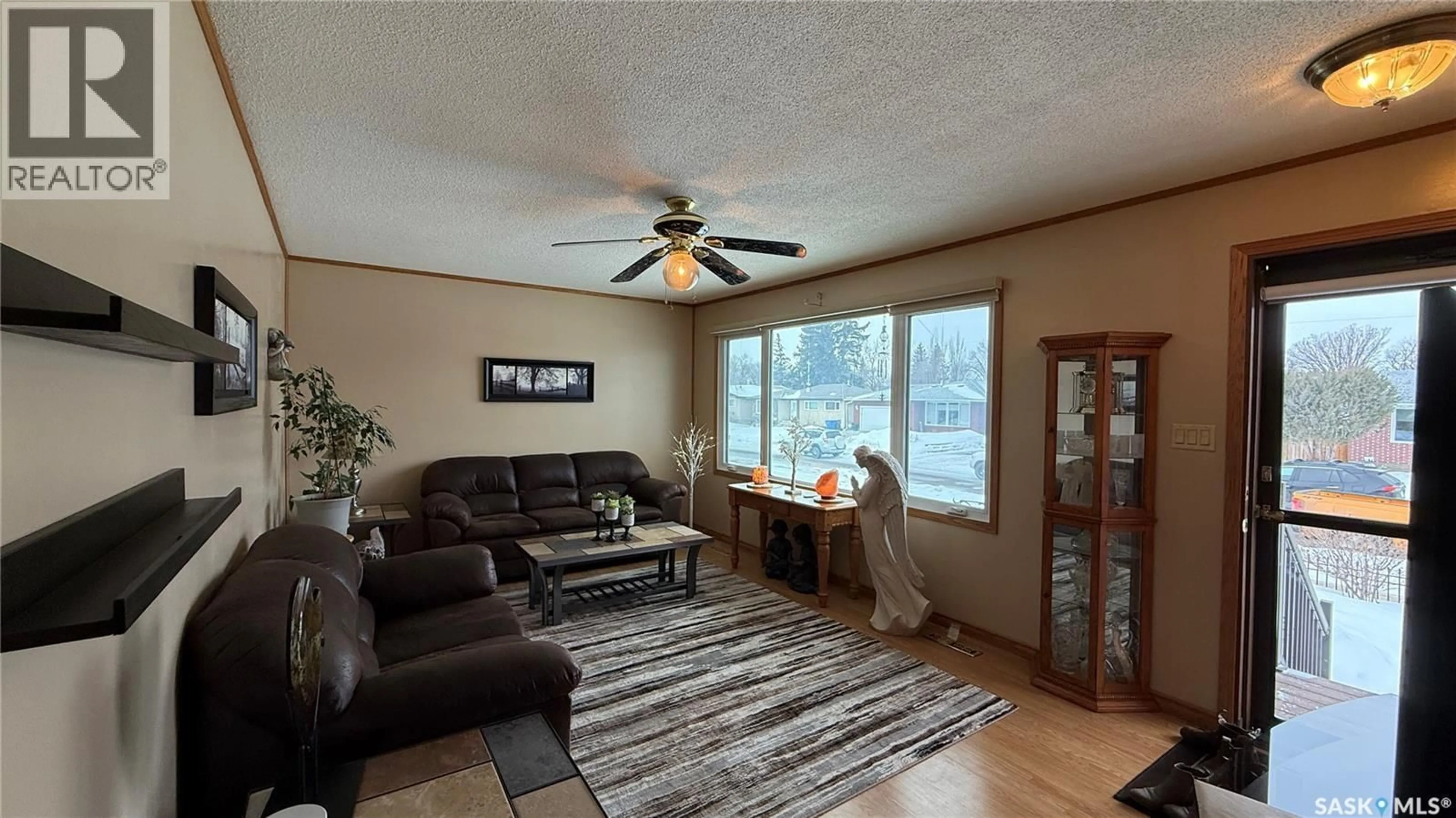Living room with furniture, wood/laminate floor for 1742 105TH STREET, North Battleford Saskatchewan S9A1V1