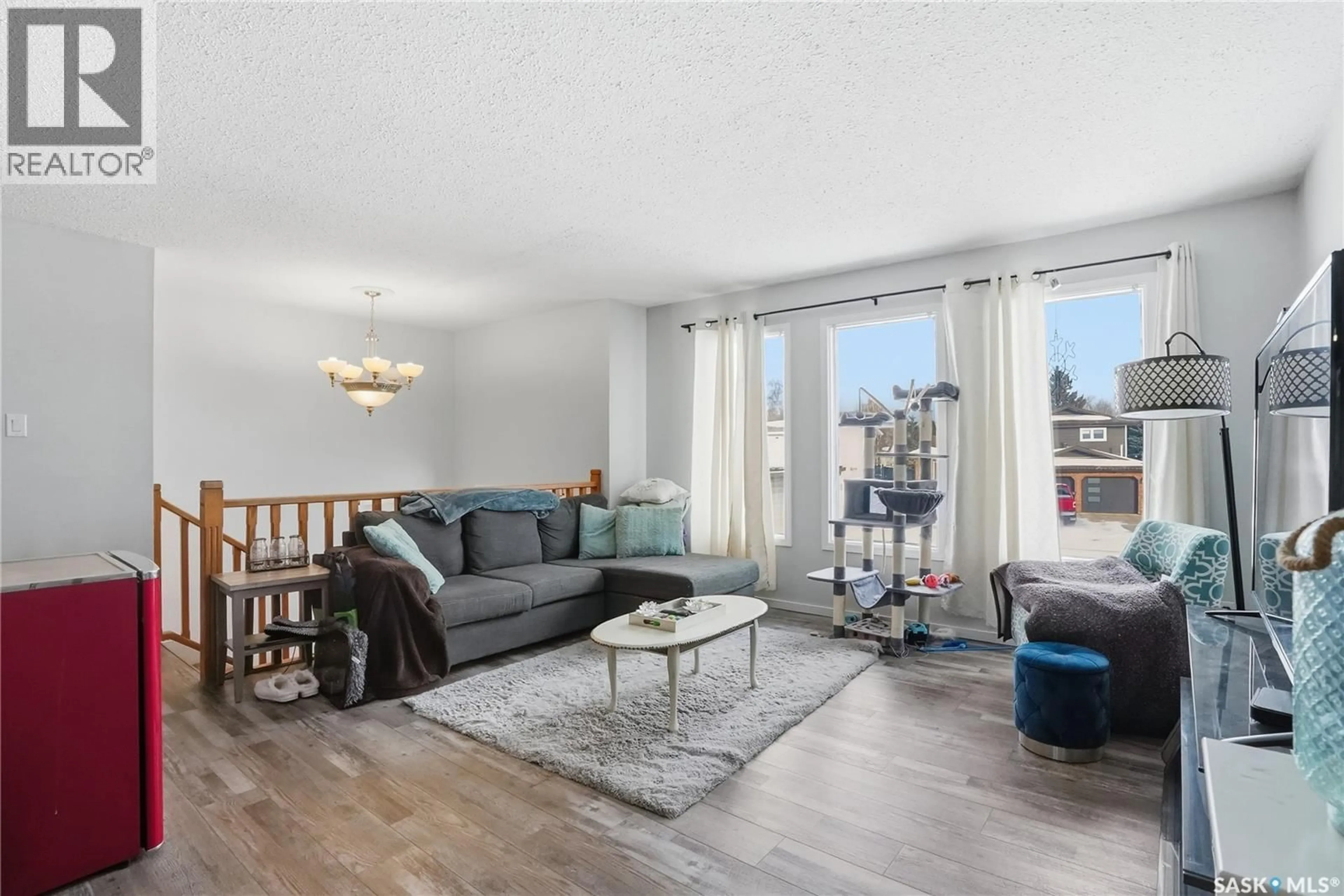 Living room with furniture, wood/laminate floor for 3317 EAGLE CRESCENT, Prince Albert Saskatchewan S6V7R1