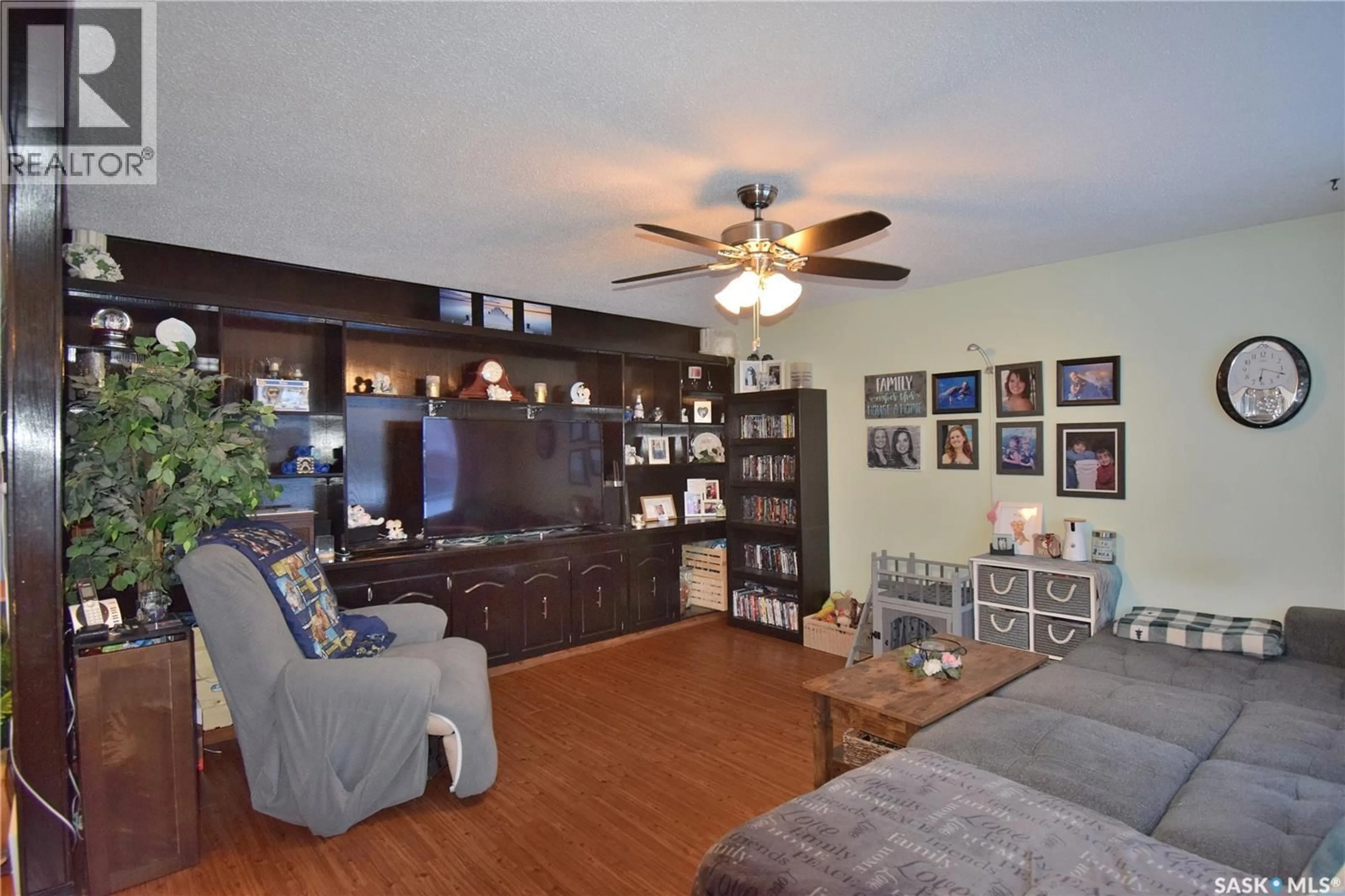 Living room with furniture, wood/laminate floor for 1571 1ST STREET, Prince Albert Saskatchewan S6V0E8