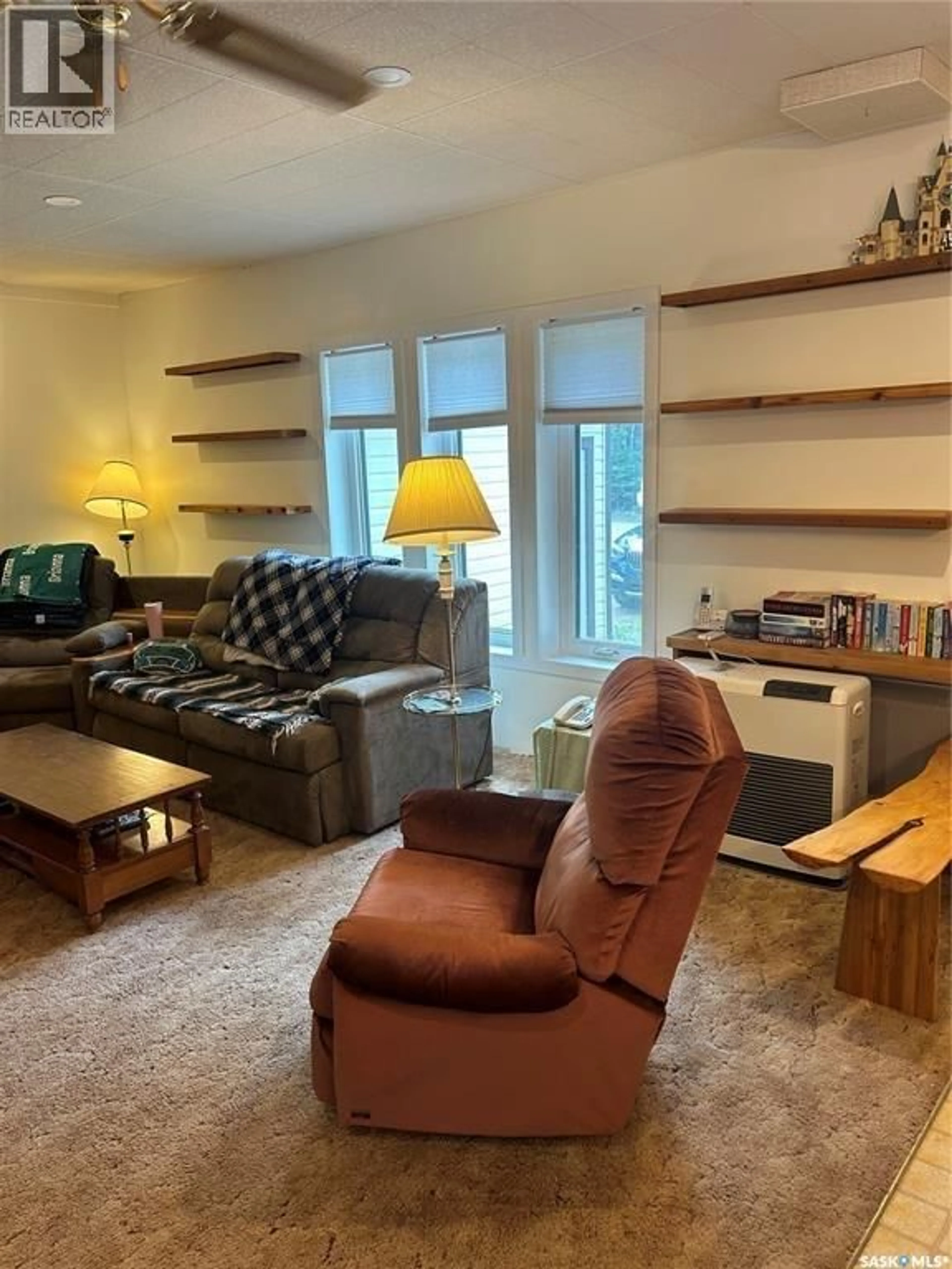 Living room with furniture, wood/laminate floor for 513 TAMARACK PLACE, Northern Admin District Saskatchewan S0J2J0