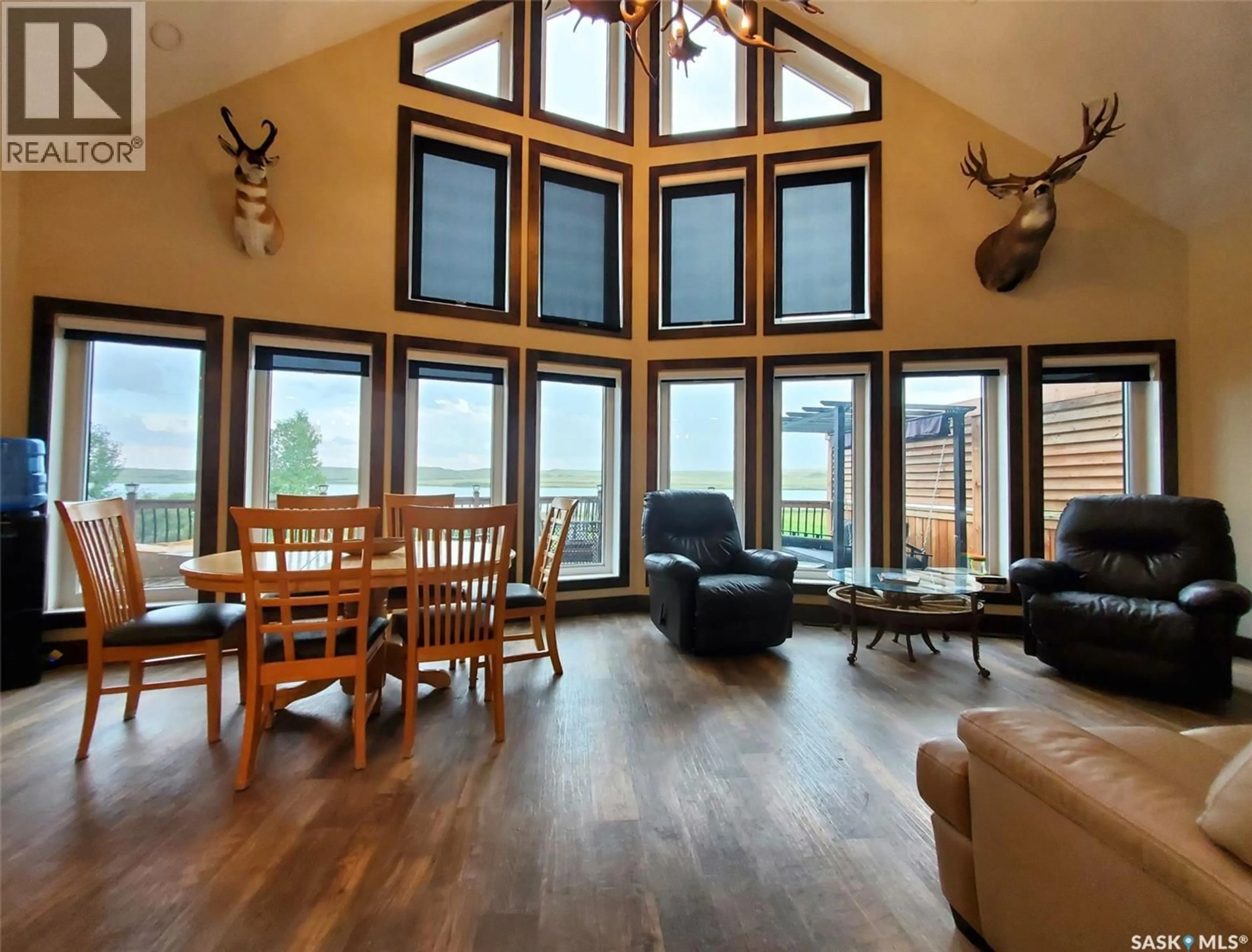 Living room with furniture, wood/laminate floor for 101 PEBBLE DRIVE, Webb Rm No. 138 Saskatchewan S0N2X0