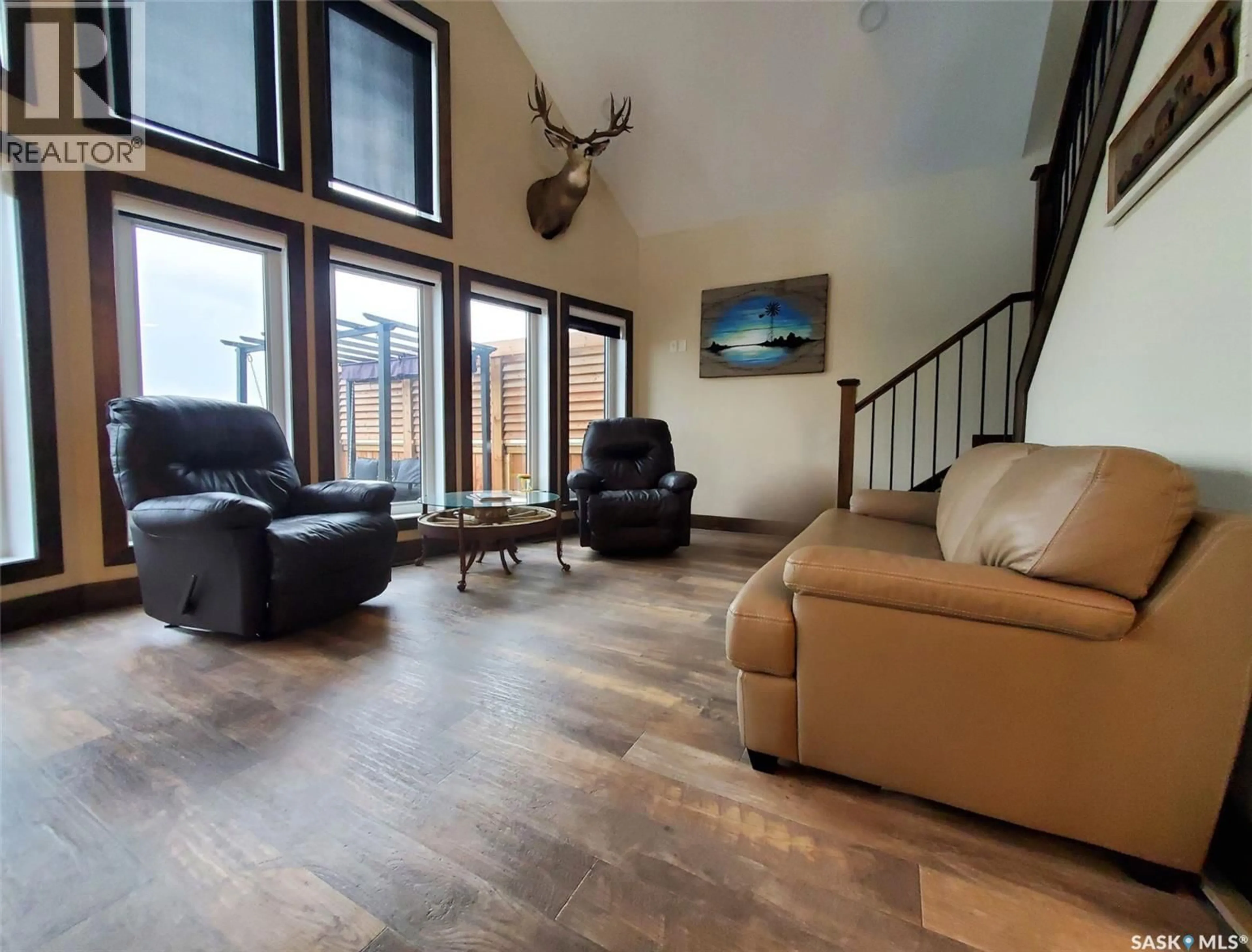 Living room with furniture, wood/laminate floor for 101 PEBBLE DRIVE, Webb Rm No. 138 Saskatchewan S0N2X0