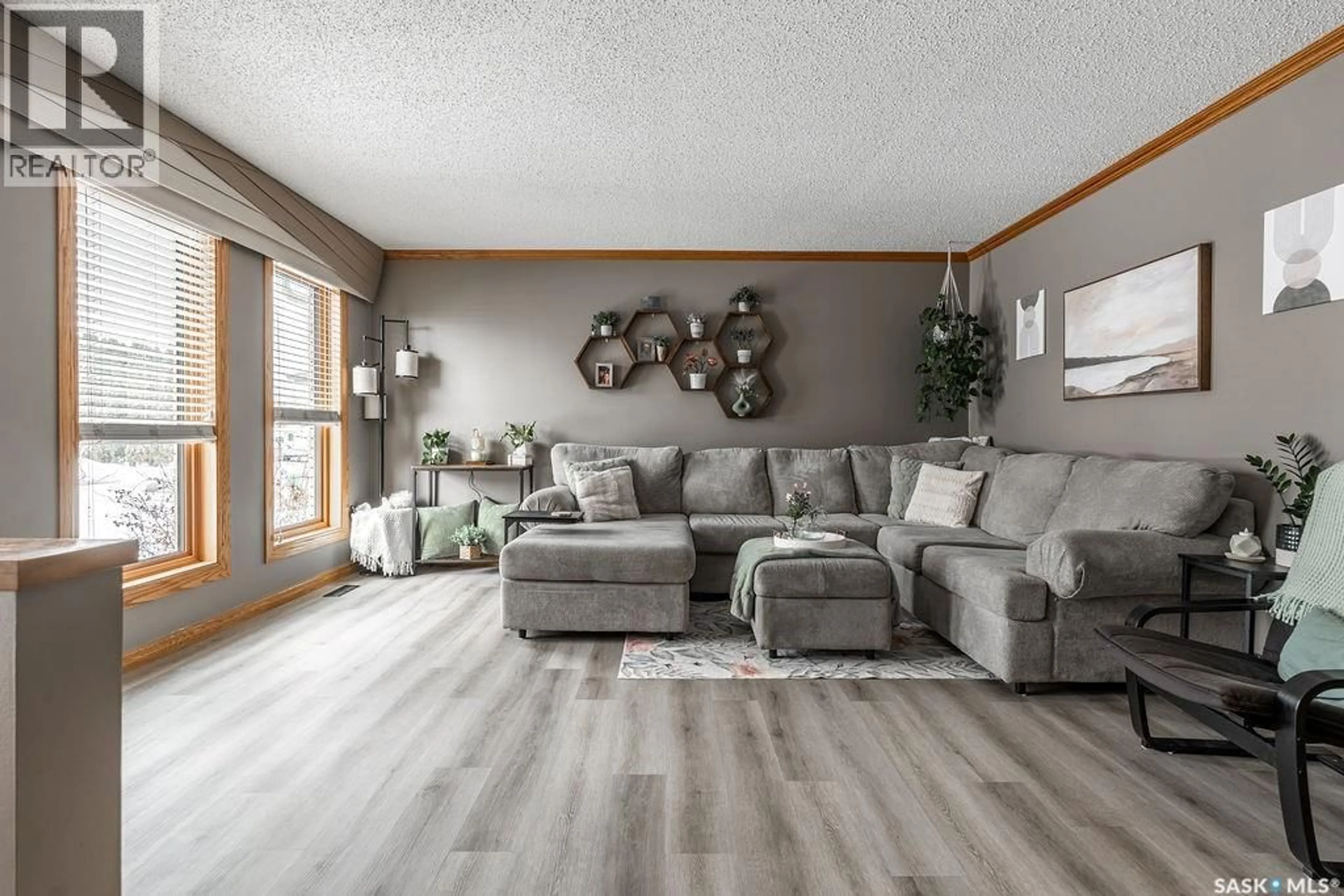Living room with furniture, wood/laminate floor for 326 BORNSTEIN CRESCENT, Saskatoon Saskatchewan S7N3Y3