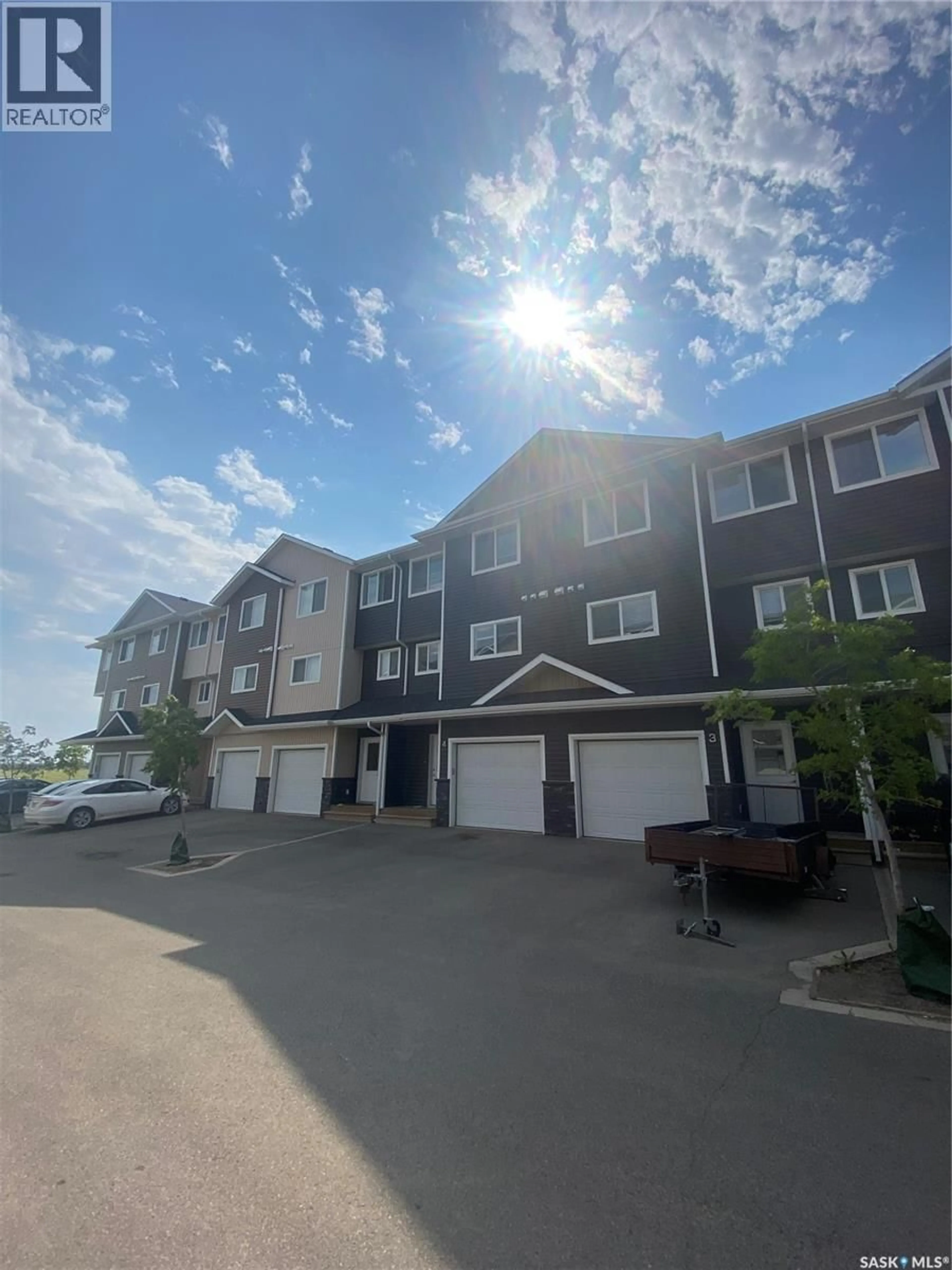 A pic from outside/outdoor area/front of a property/back of a property/a pic from drone, unknown for 4 - 1060 PARR HILL DRIVE, Martensville Saskatchewan S0K2T1