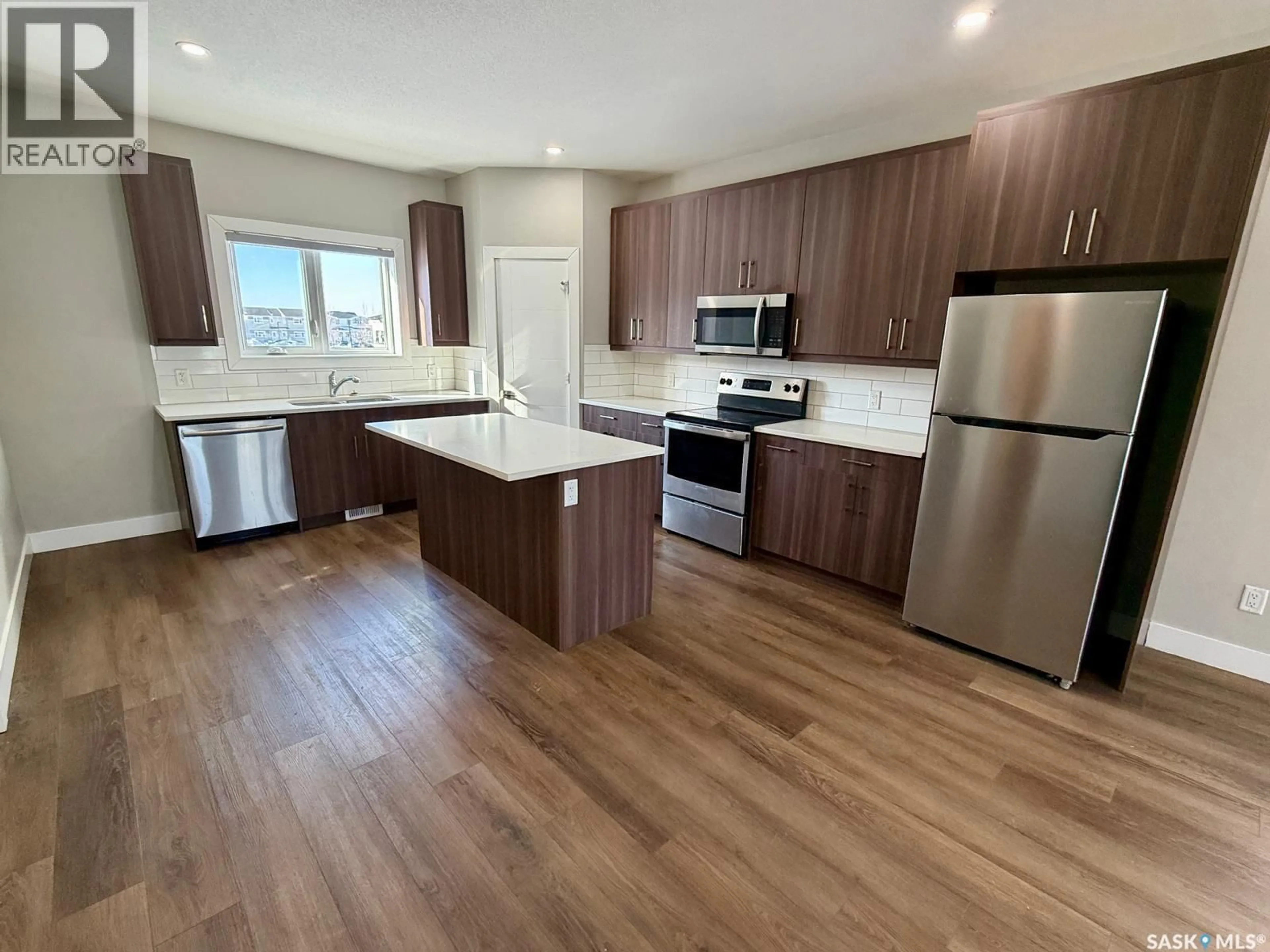 Open concept kitchen, wood/laminate floor for 3330 GREEN TURTLE ROAD, Regina Saskatchewan S4V3N6