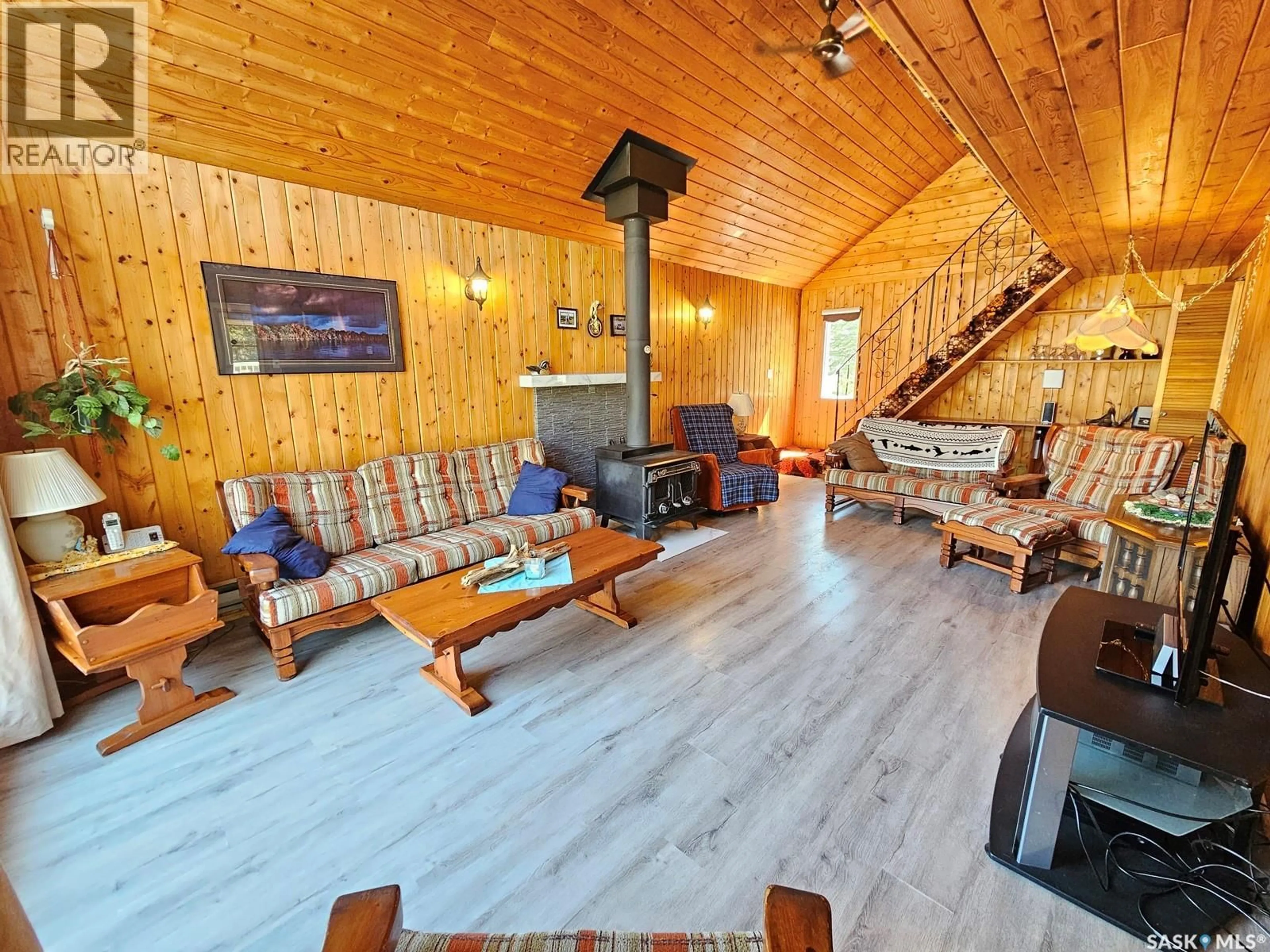 Living room with furniture, wood/laminate floor for 303 CHRISTEL CRESCENT, Beaver River Rm No. 622 Saskatchewan S0M1A0