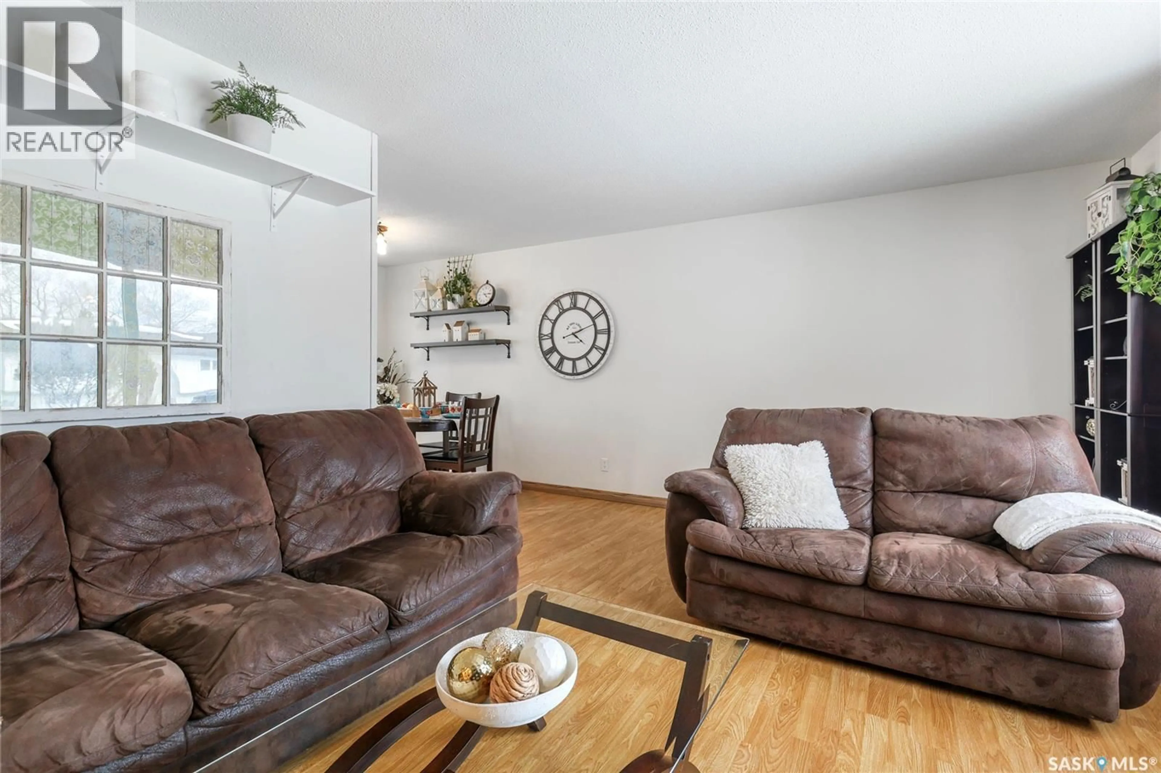 Living room with furniture, wood/laminate floor for 251 HANLEY CRESCENT, Regina Saskatchewan S4R5A9