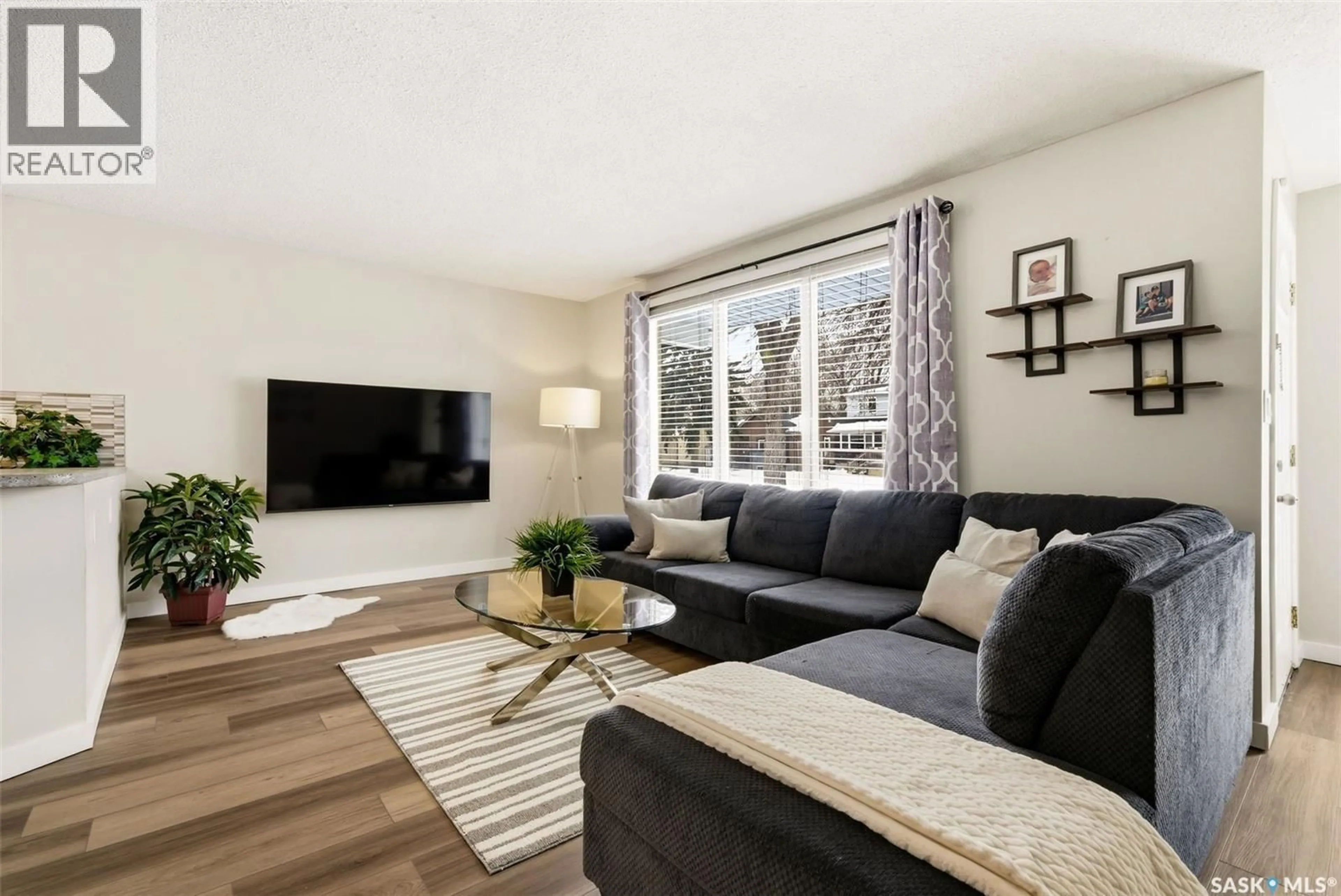 Living room with furniture, wood/laminate floor for 3231 RETALLACK STREET, Regina Saskatchewan S4S1T7