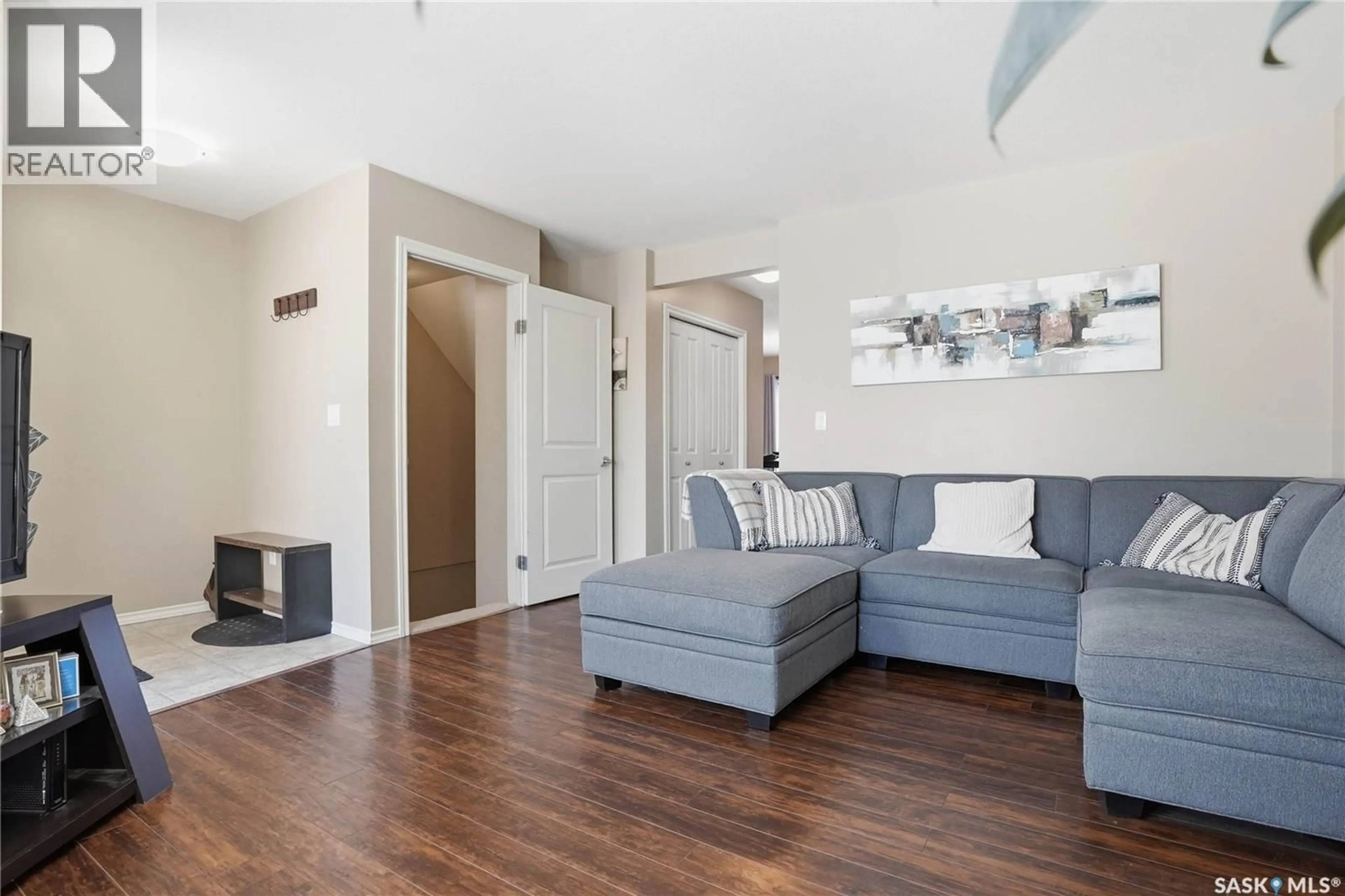 Living room with furniture, wood/laminate floor for 303 - 619 SLIMMON PLACE, Saskatoon Saskatchewan S7V0A8