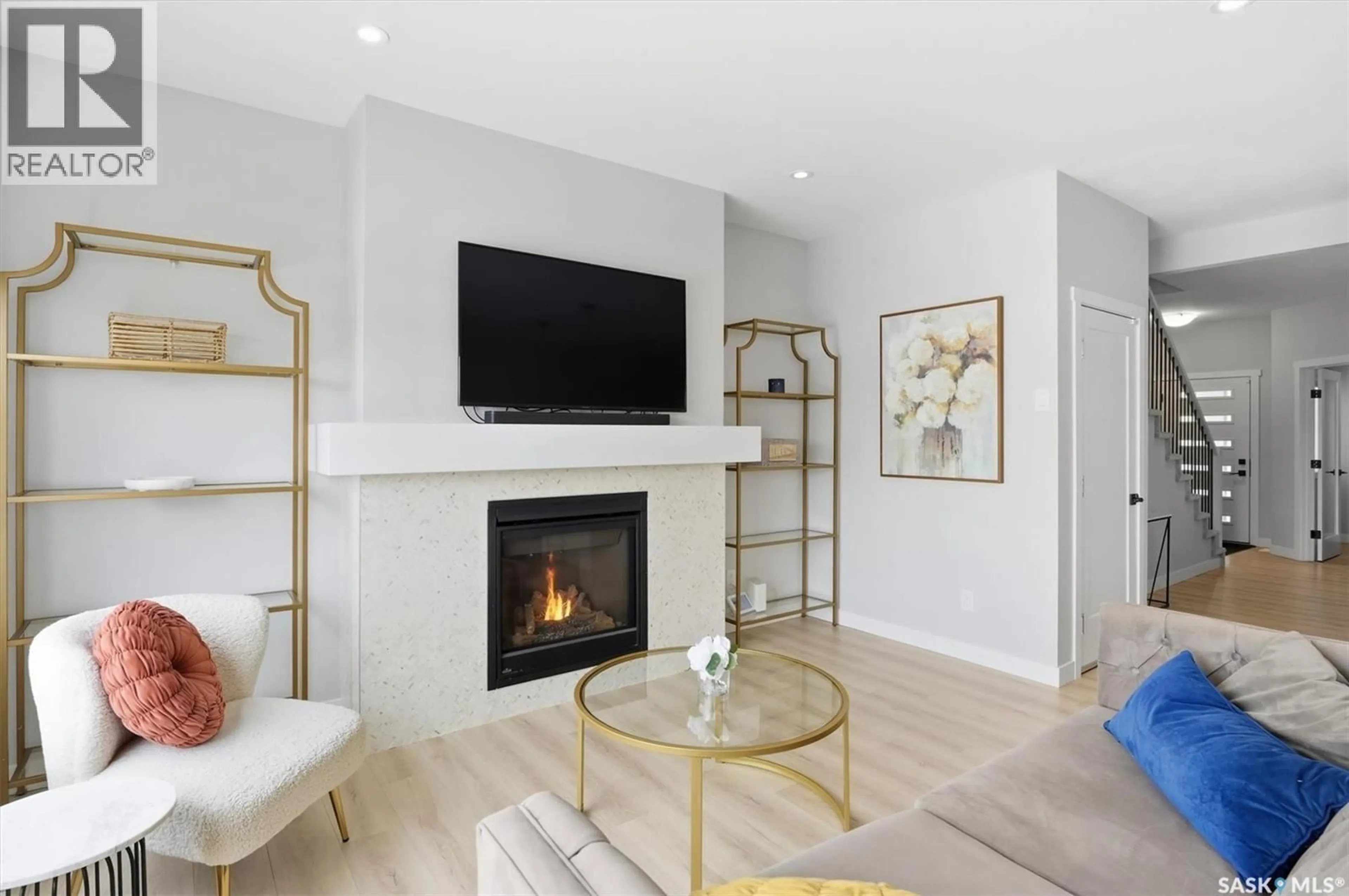 Living room with furniture, wood/laminate floor for 406 CHELSOM MANOR, Saskatoon Saskatchewan S7V0Z7