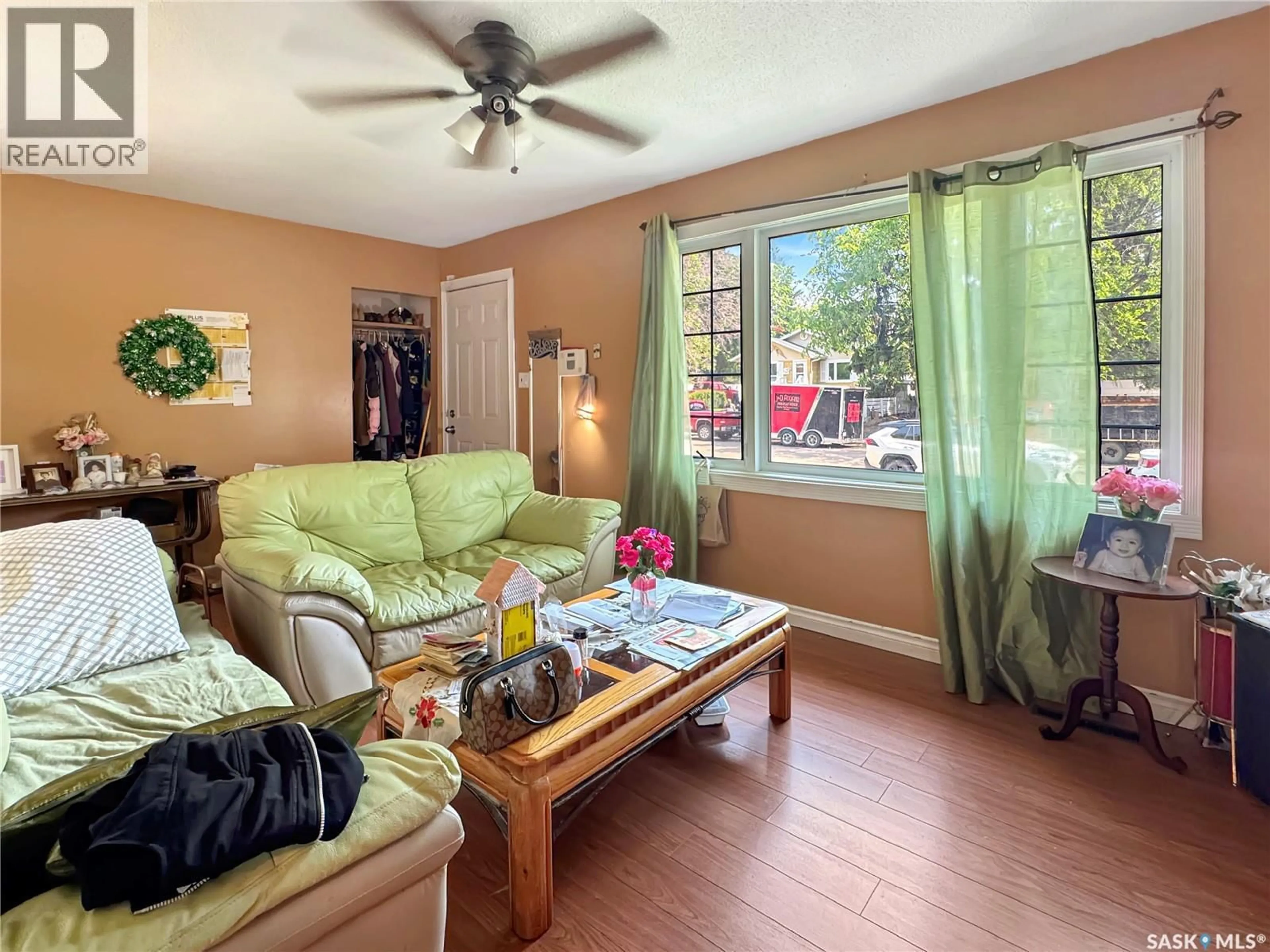 Living room with furniture, wood/laminate floor for 1571 105TH STREET, North Battleford Saskatchewan S9A1T5