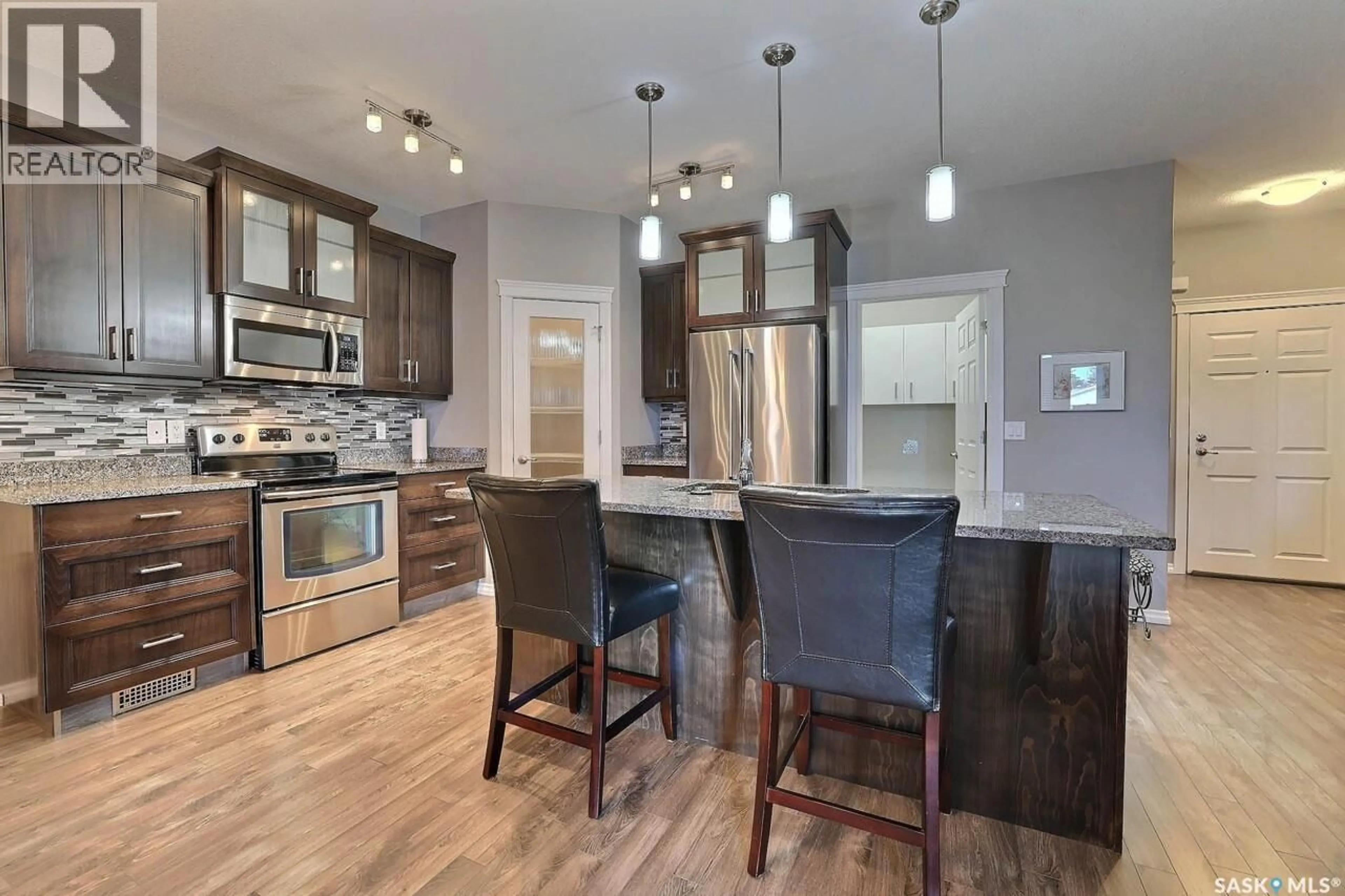 Open concept kitchen, wood/laminate floor for 4721 - 201 MCTAVISH STREET, Regina Saskatchewan S4S6H2
