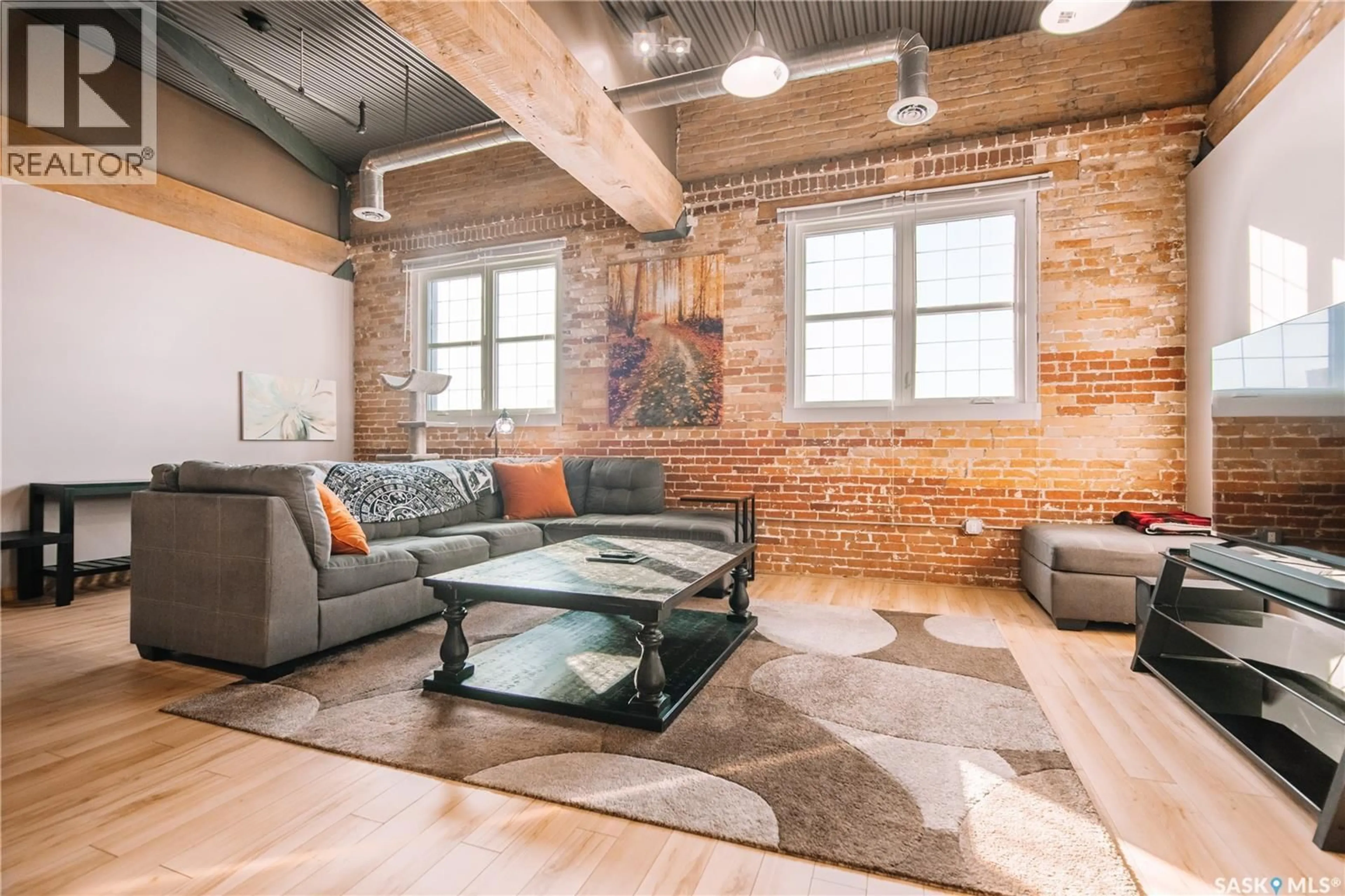 Living room with furniture, cement floor for 304 1170 BROAD STREET, Regina Saskatchewan S4R1X2