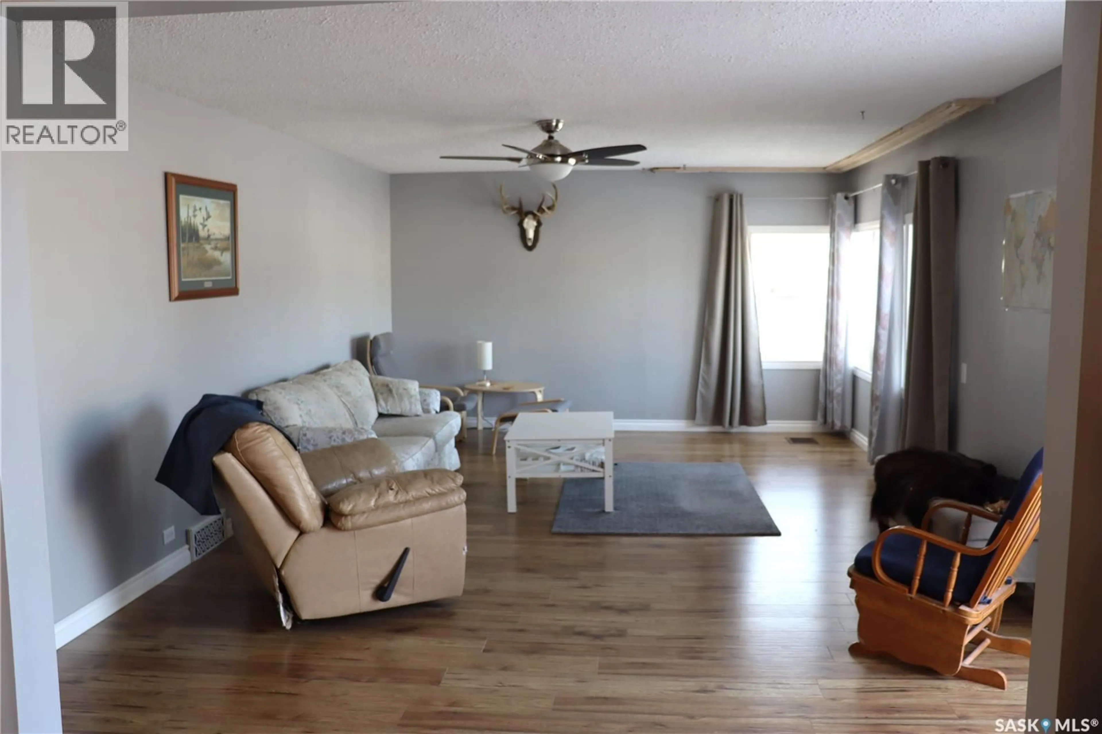 Living room with furniture, wood/laminate floor for 217 2ND AVENUE, Debden Saskatchewan S0J0S0
