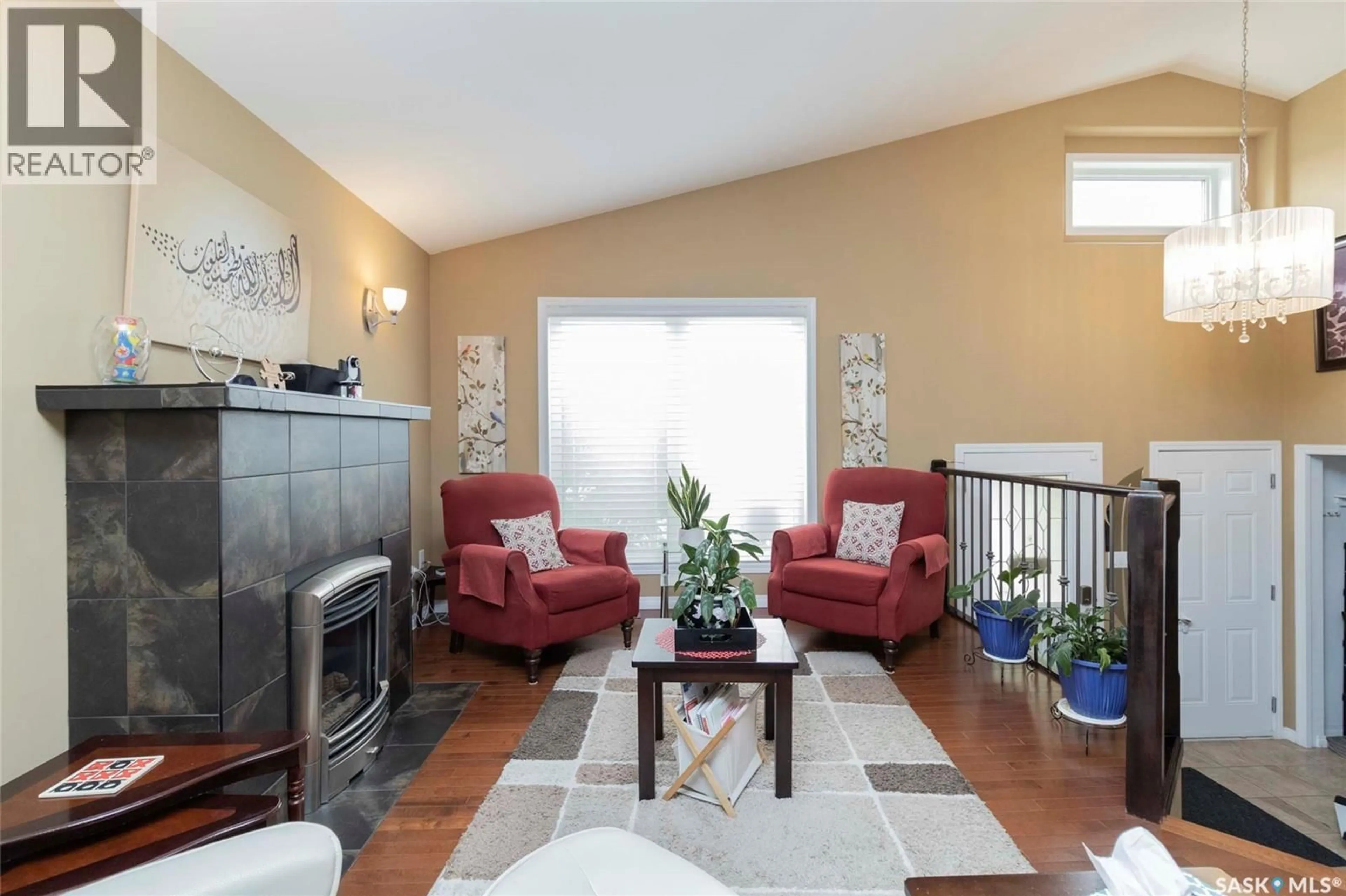 Living room with furniture, wood/laminate floor for 531 DICKSON LANE, Saskatoon Saskatchewan S7T0H7