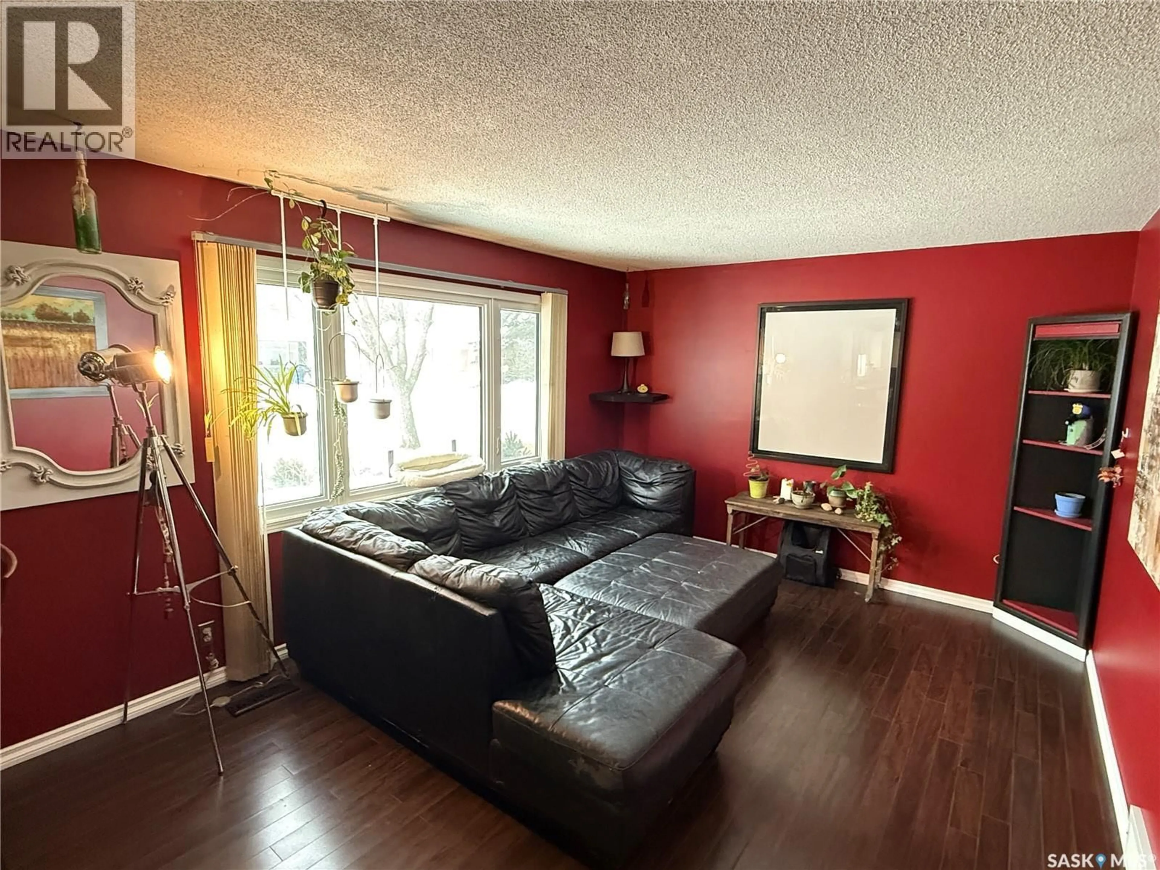Living room with furniture, wood/laminate floor for 708 BRIMACOMBE DRIVE, Weyburn Saskatchewan S4H2P8