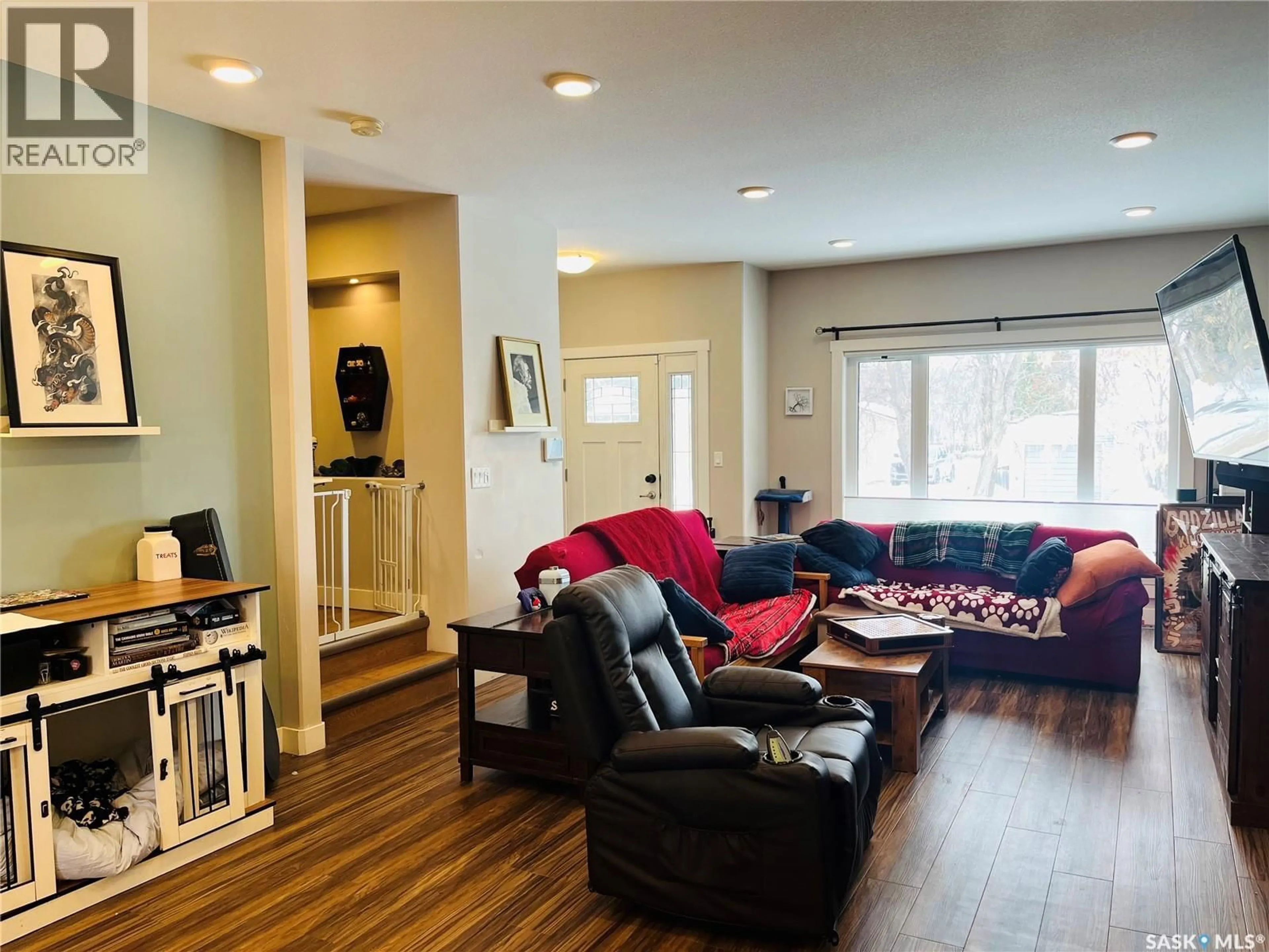 Living room with furniture, wood/laminate floor for 1411 2ND AVENUE, Saskatoon Saskatchewan S7K2G5