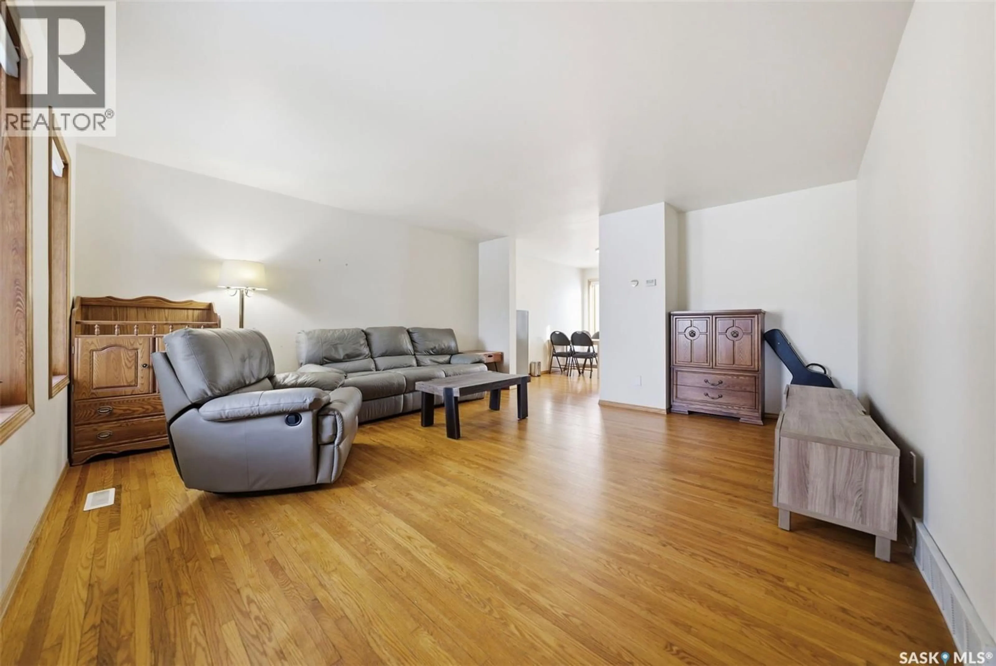 Living room with furniture, wood/laminate floor for 407 111TH STREET, Saskatoon Saskatchewan S7N1T6