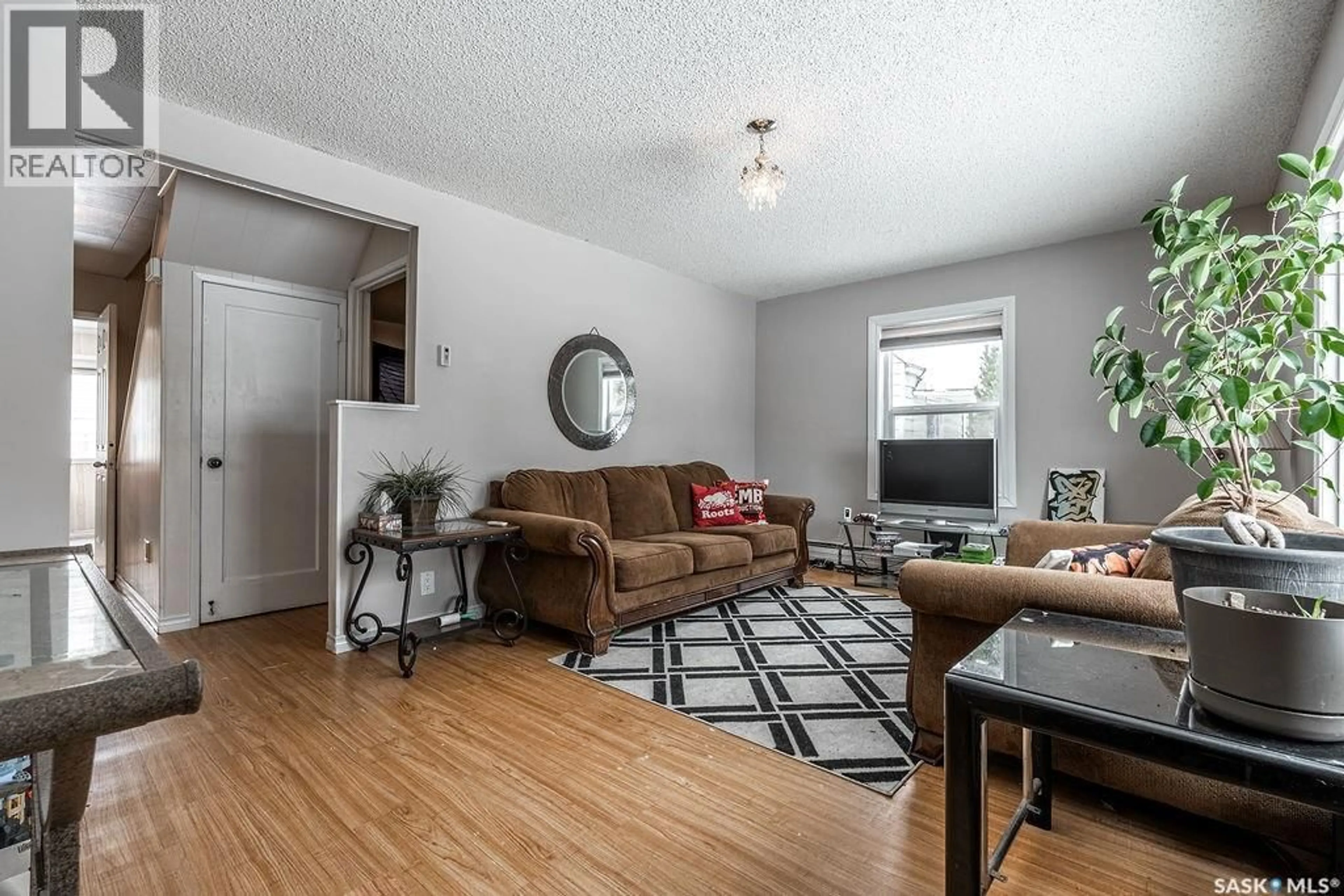 Living room with furniture, wood/laminate floor for 133 111TH STREET, Saskatoon Saskatchewan S7J3L8
