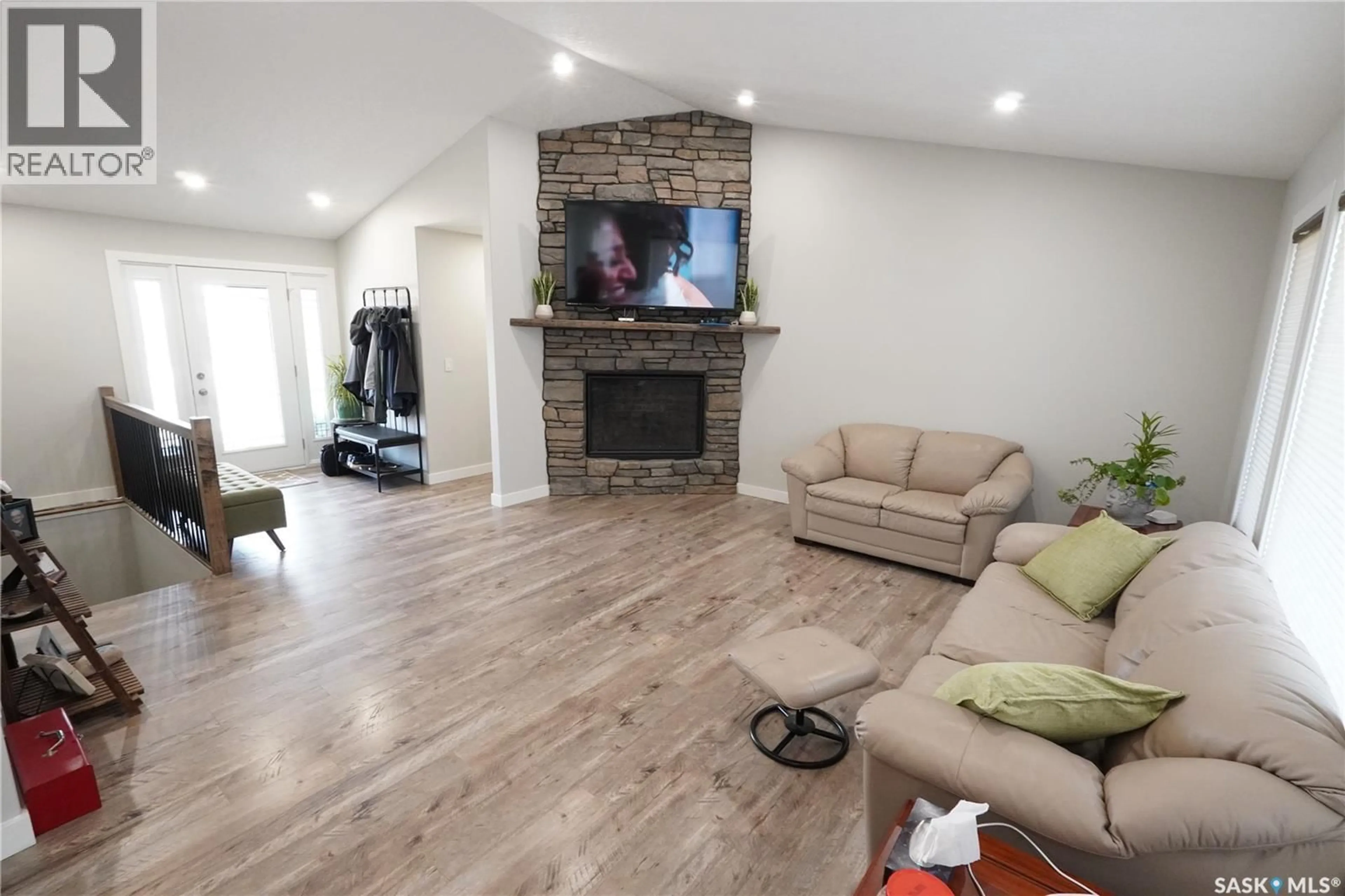Living room with furniture, wood/laminate floor for 44 CRESCENT DRIVE, Avonlea Saskatchewan S0H0C0