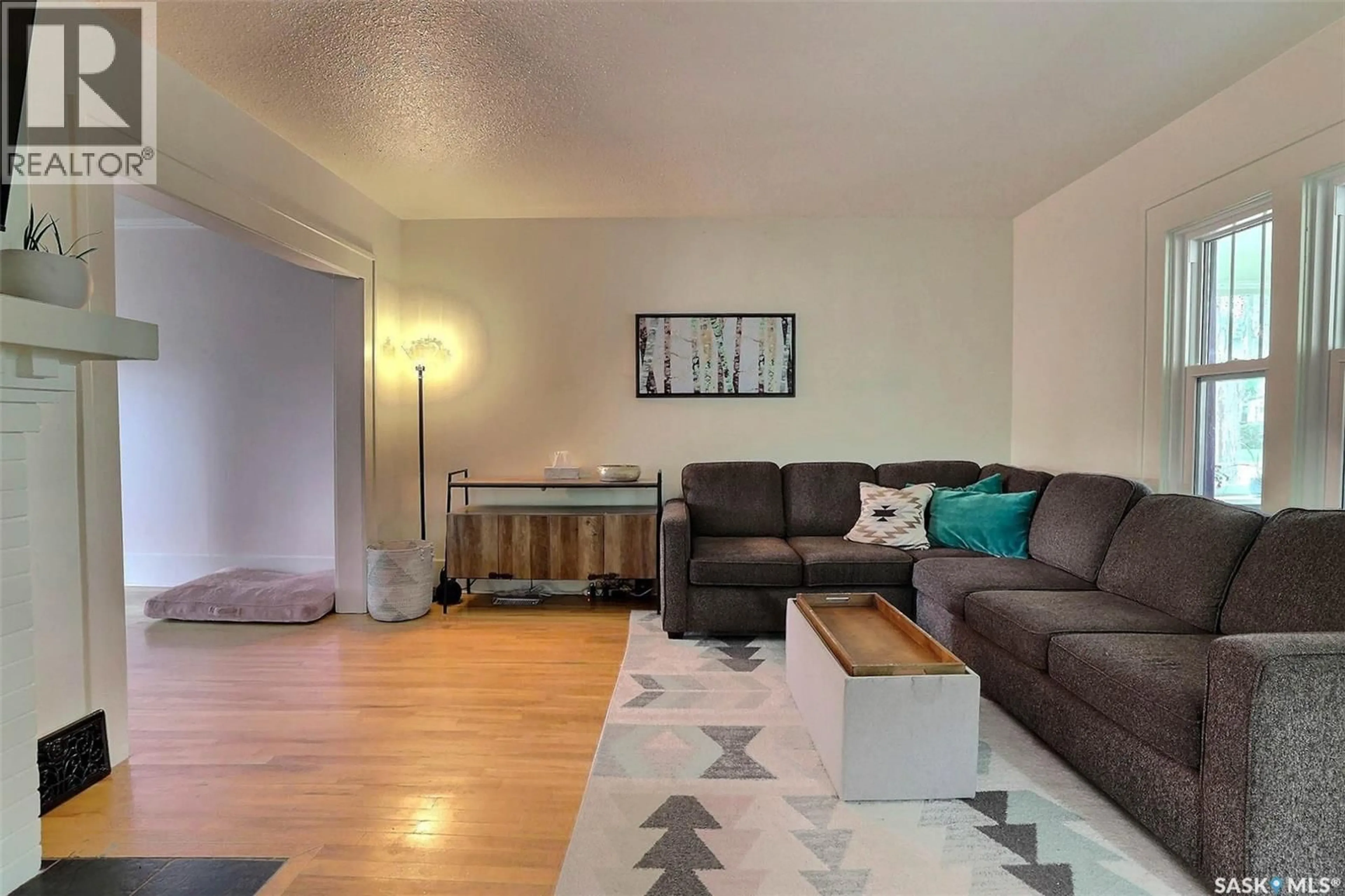 Living room with furniture, wood/laminate floor for 3408 VICTORIA AVENUE, Regina Saskatchewan S4T1L8