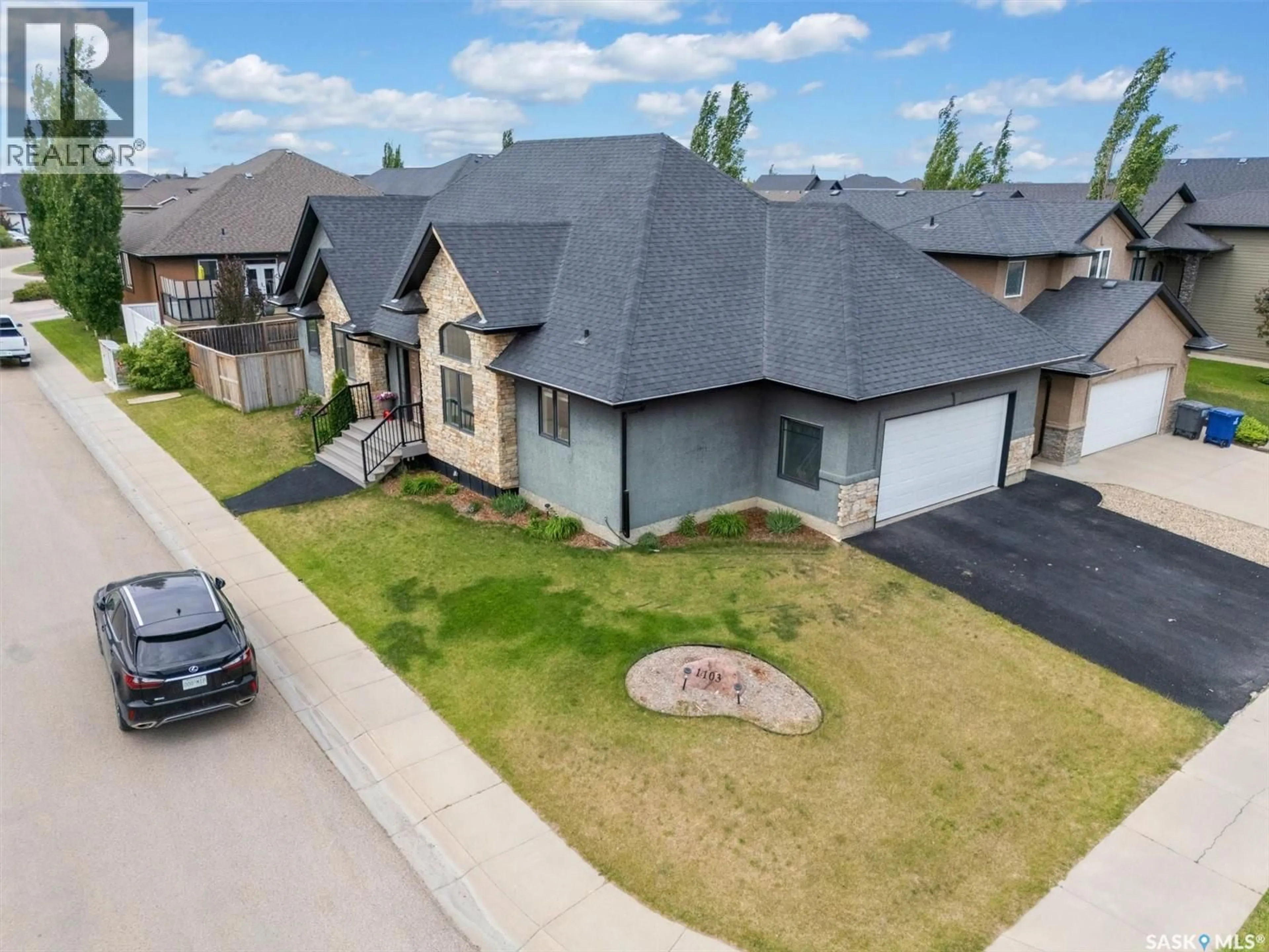 A pic from outside/outdoor area/front of a property/back of a property/a pic from drone, street for 1103 STENSRUD ROAD, Saskatoon Saskatchewan S7W0C9