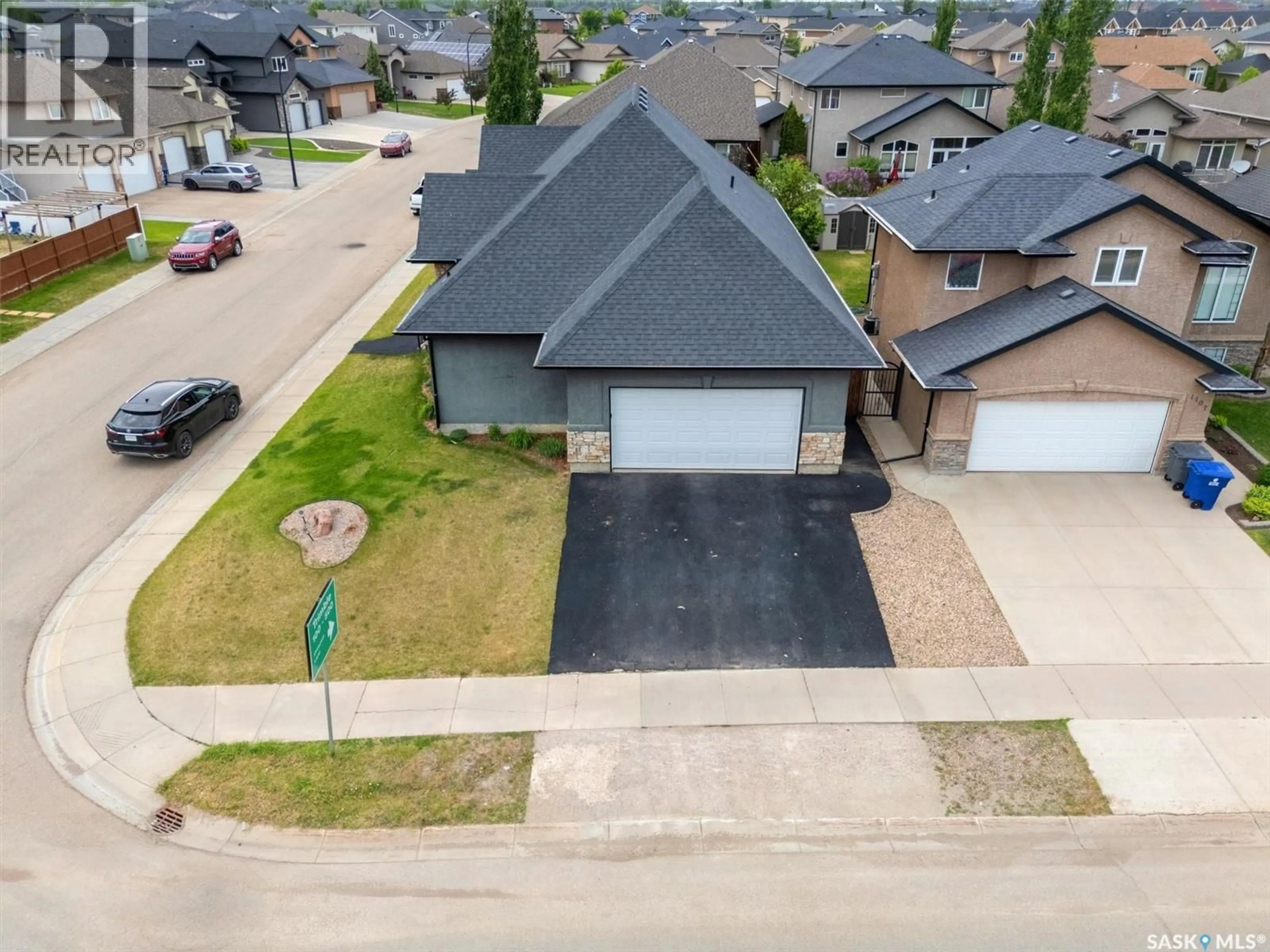 A pic from outside/outdoor area/front of a property/back of a property/a pic from drone, street for 1103 STENSRUD ROAD, Saskatoon Saskatchewan S7W0C9