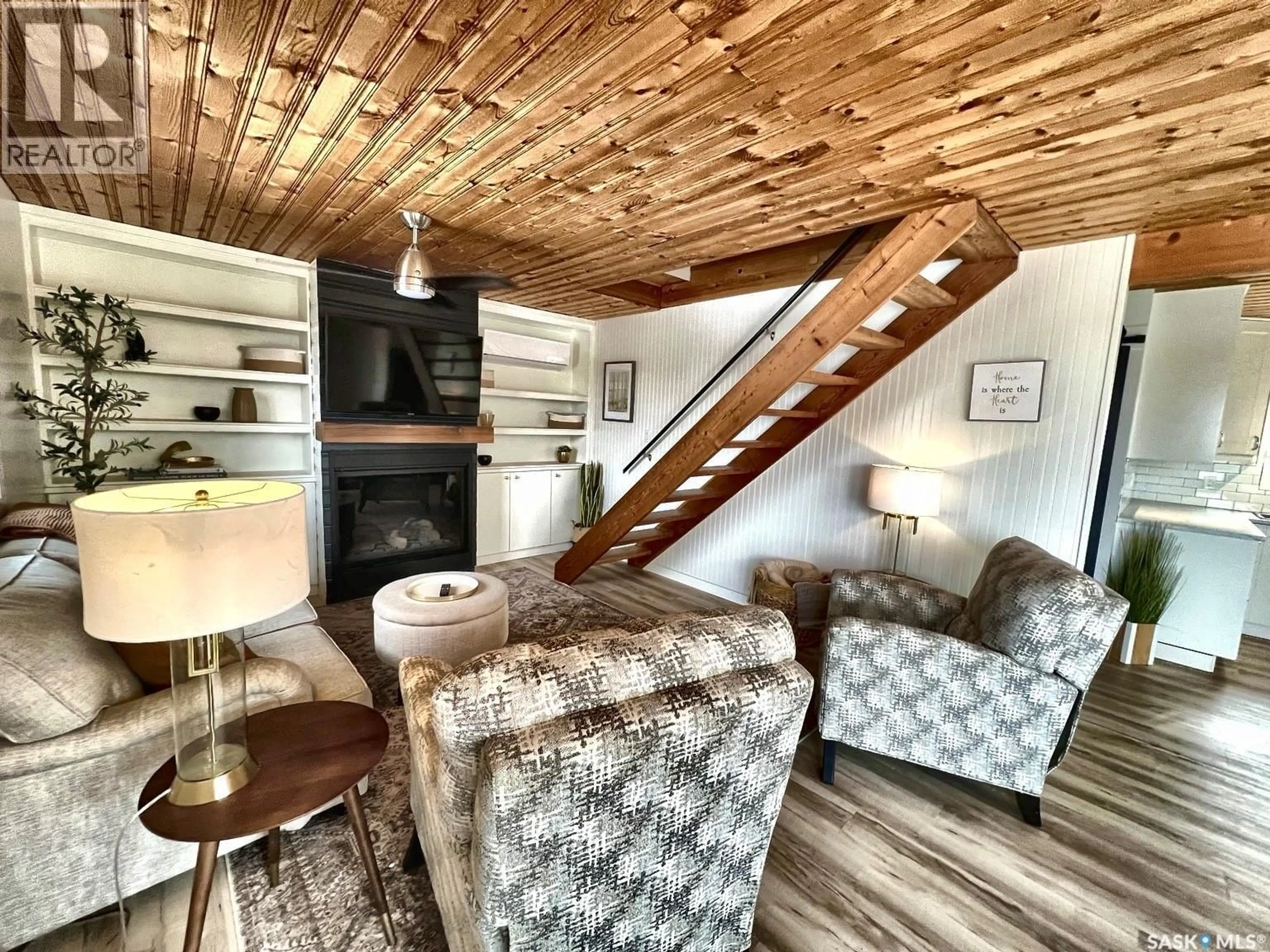 Living room with furniture, wood/laminate floor for 79 SNEDDEN CRESCENT, Maple Bush Rm No. 224 Saskatchewan S0H3P0