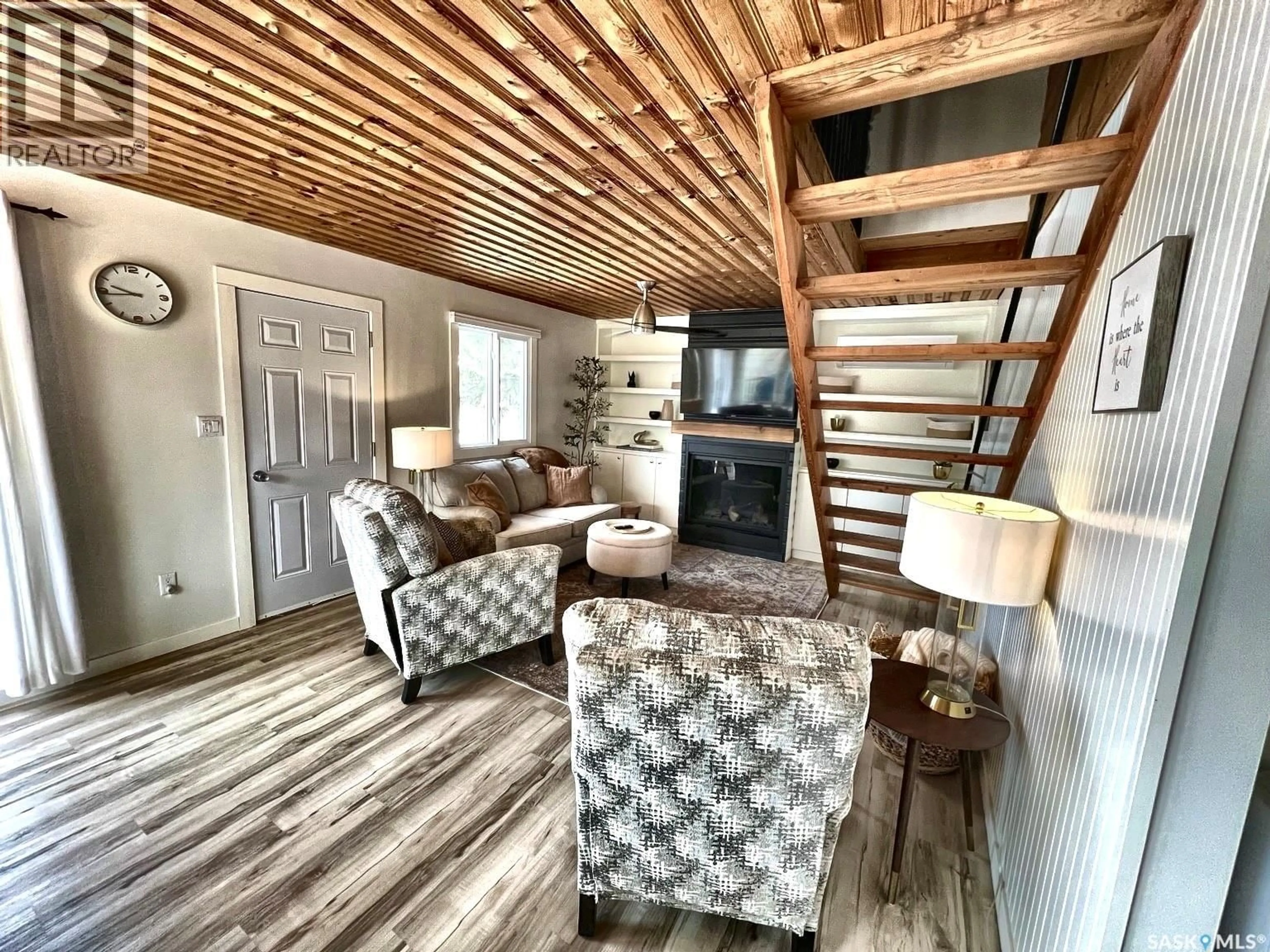 Living room with furniture, wood/laminate floor for 79 SNEDDEN CRESCENT, Maple Bush Rm No. 224 Saskatchewan S0H3P0