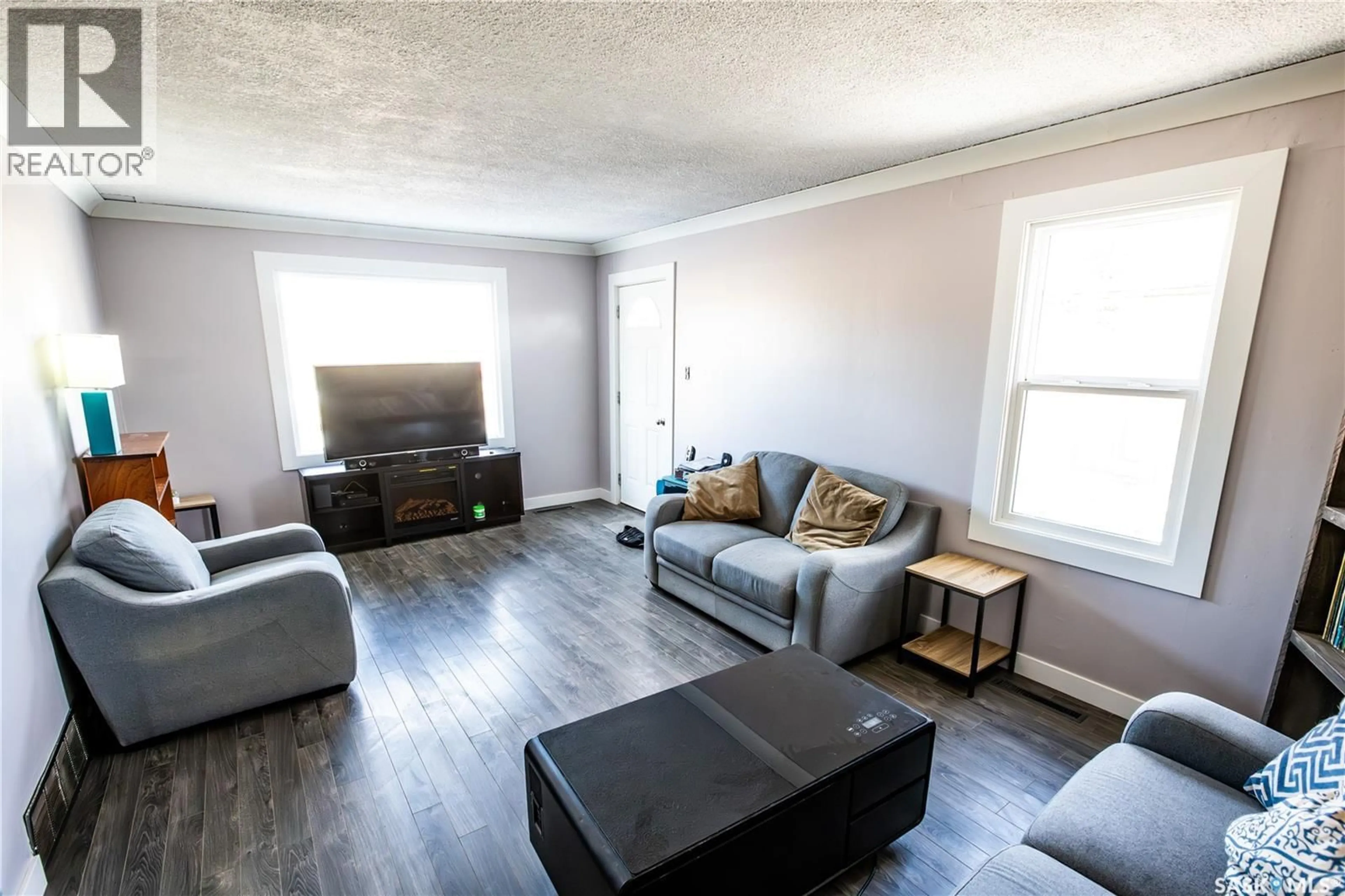 Living room with furniture, wood/laminate floor for 1021 CARIBOU STREET W, Moose Jaw Saskatchewan S6H2L6