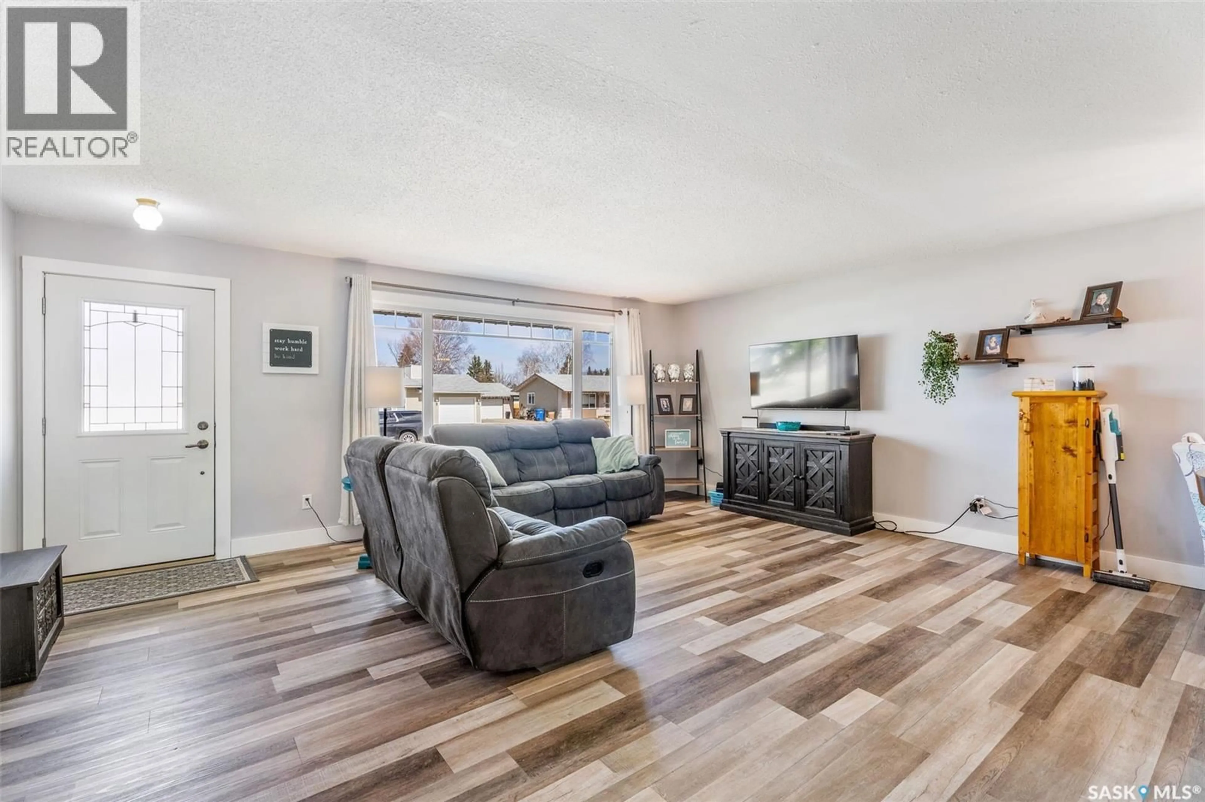 Living room with furniture, wood/laminate floor for 111 CHURCHILL DRIVE, Melfort Saskatchewan S0E1A0