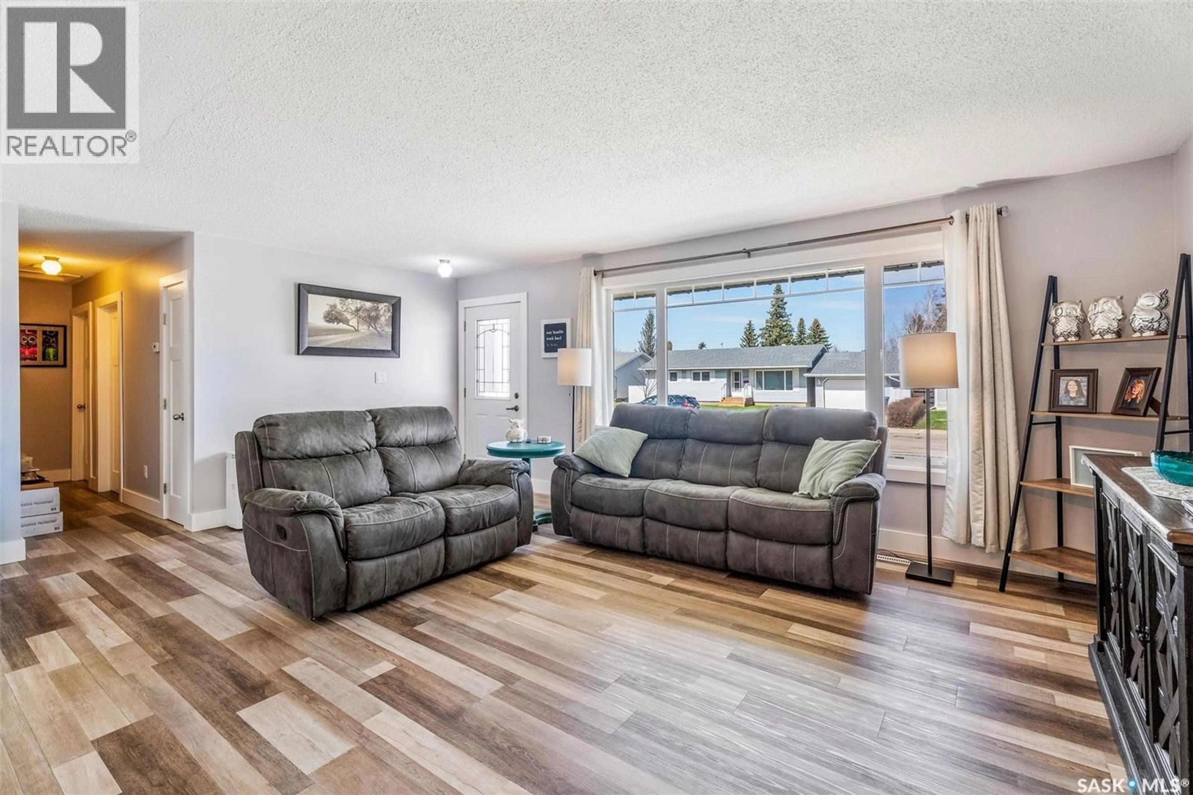 Living room with furniture, wood/laminate floor for 111 CHURCHILL DRIVE, Melfort Saskatchewan S0E1A0