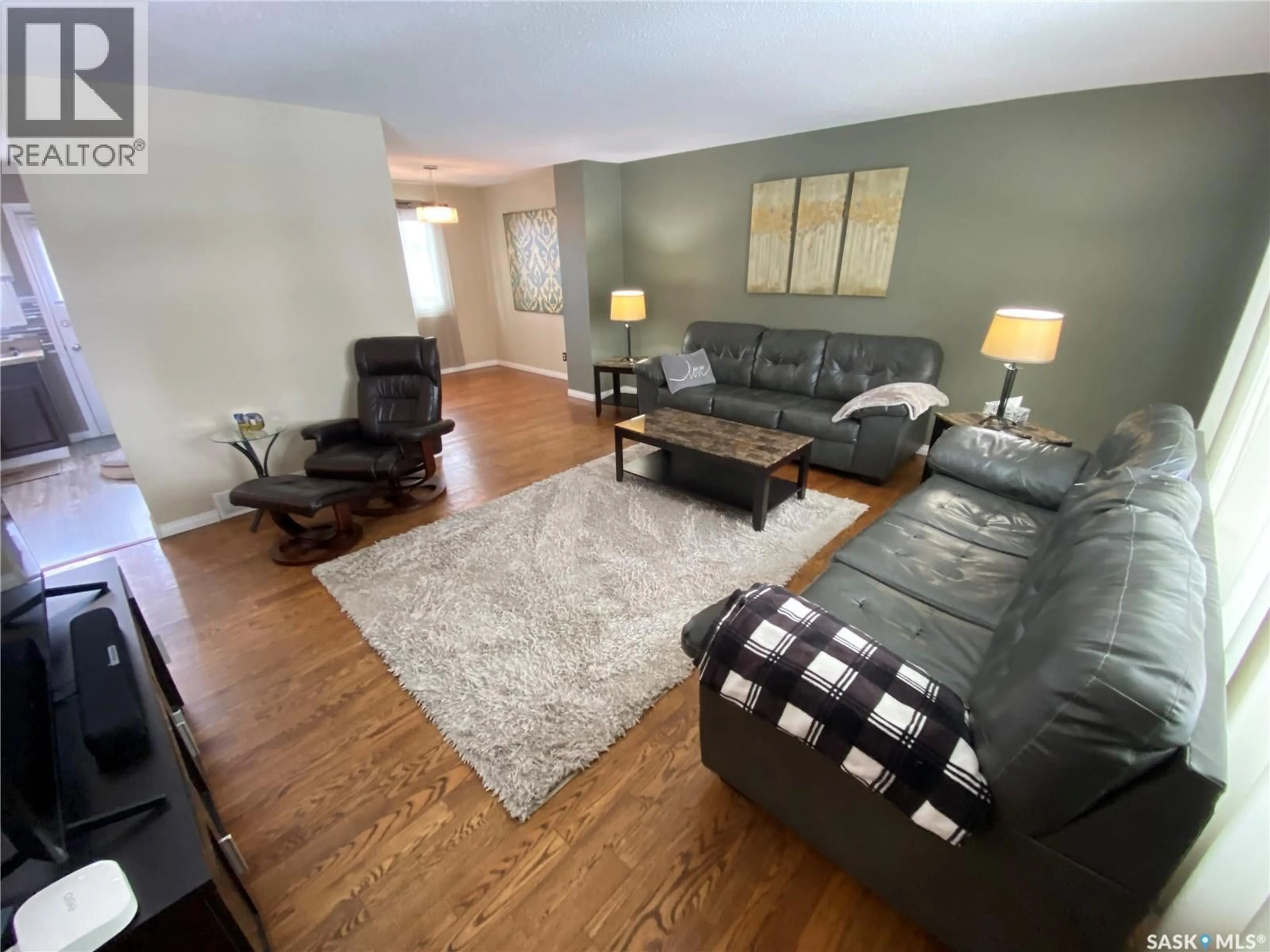 Living room with furniture, wood/laminate floor for 5 CARDINAL BAY, Yorkton Saskatchewan S3N3E4