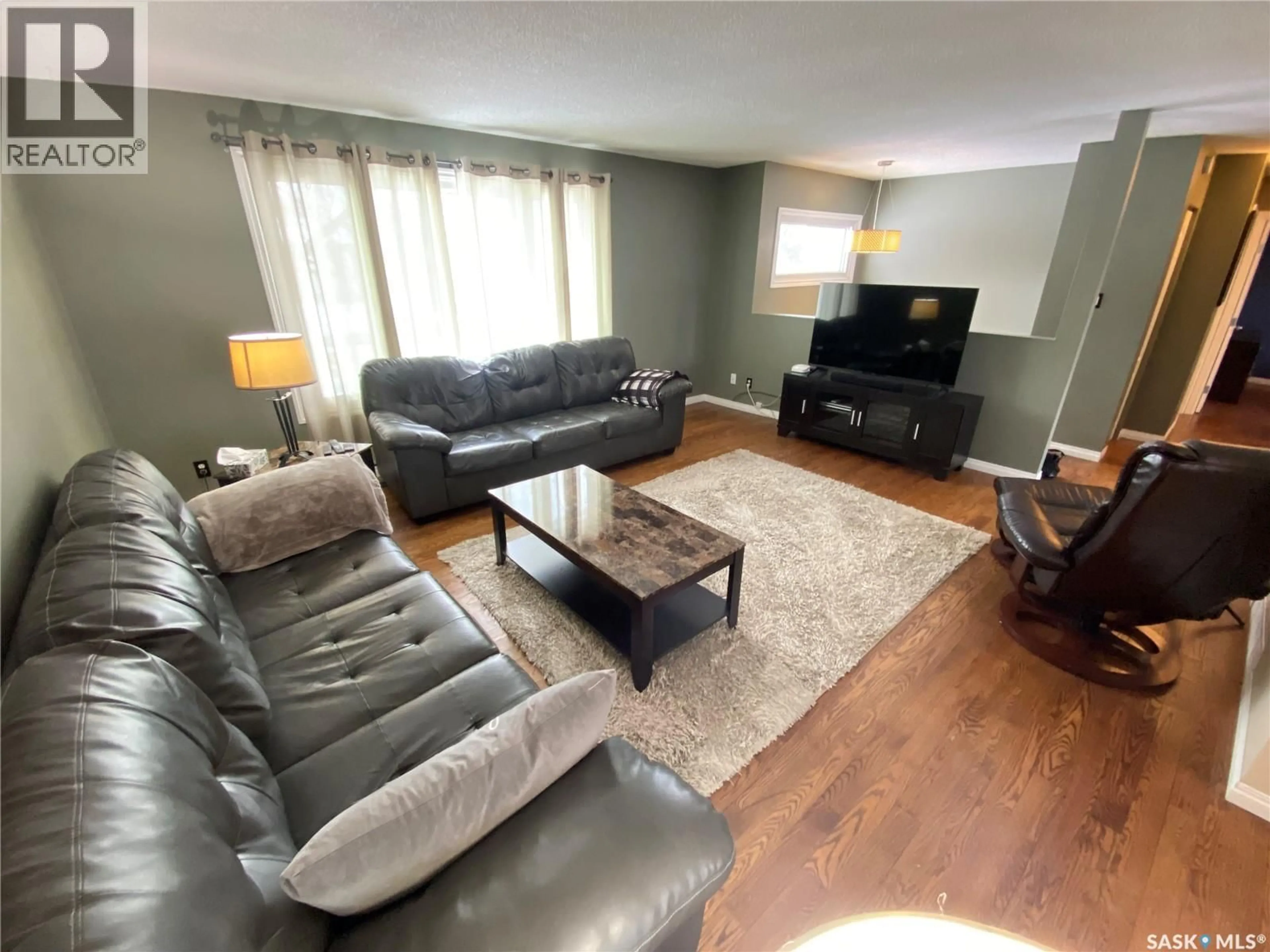 Living room with furniture, wood/laminate floor for 5 CARDINAL BAY, Yorkton Saskatchewan S3N3E4