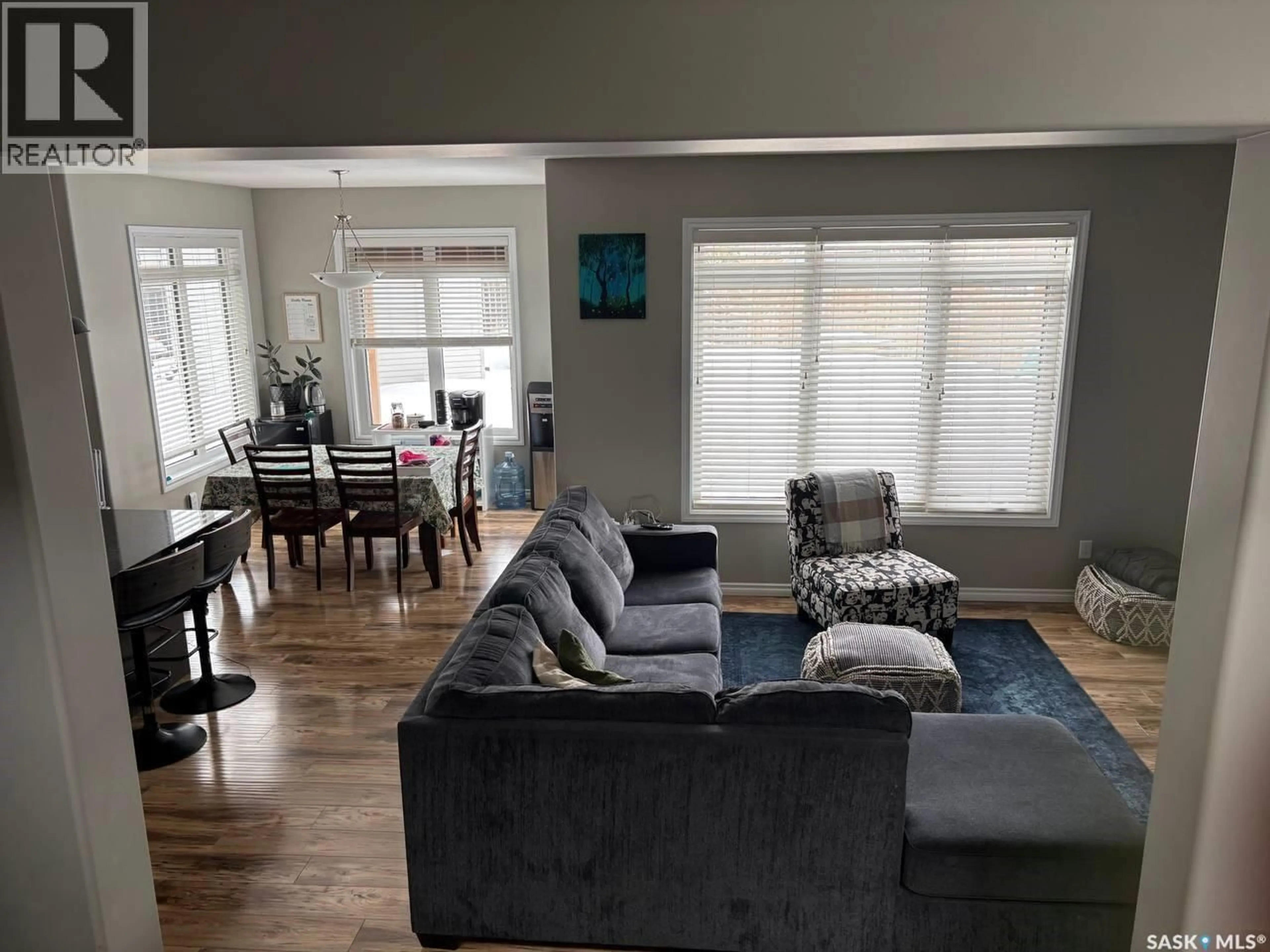 Living room with furniture, wood/laminate floor for 422 LEWIN WAY, Saskatoon Saskatchewan S7T0T3