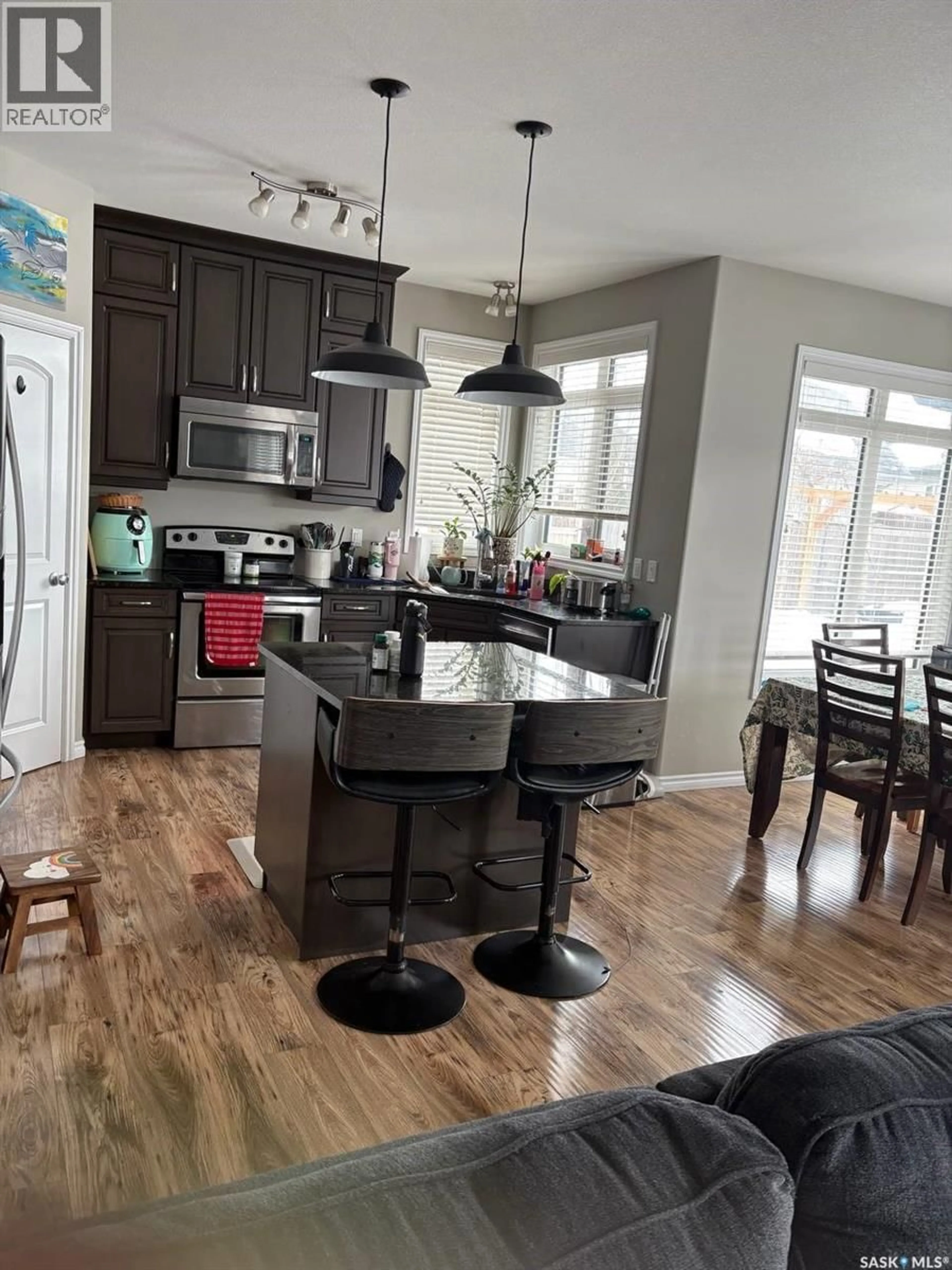 Open concept kitchen, wood/laminate floor for 422 LEWIN WAY, Saskatoon Saskatchewan S7T0T3