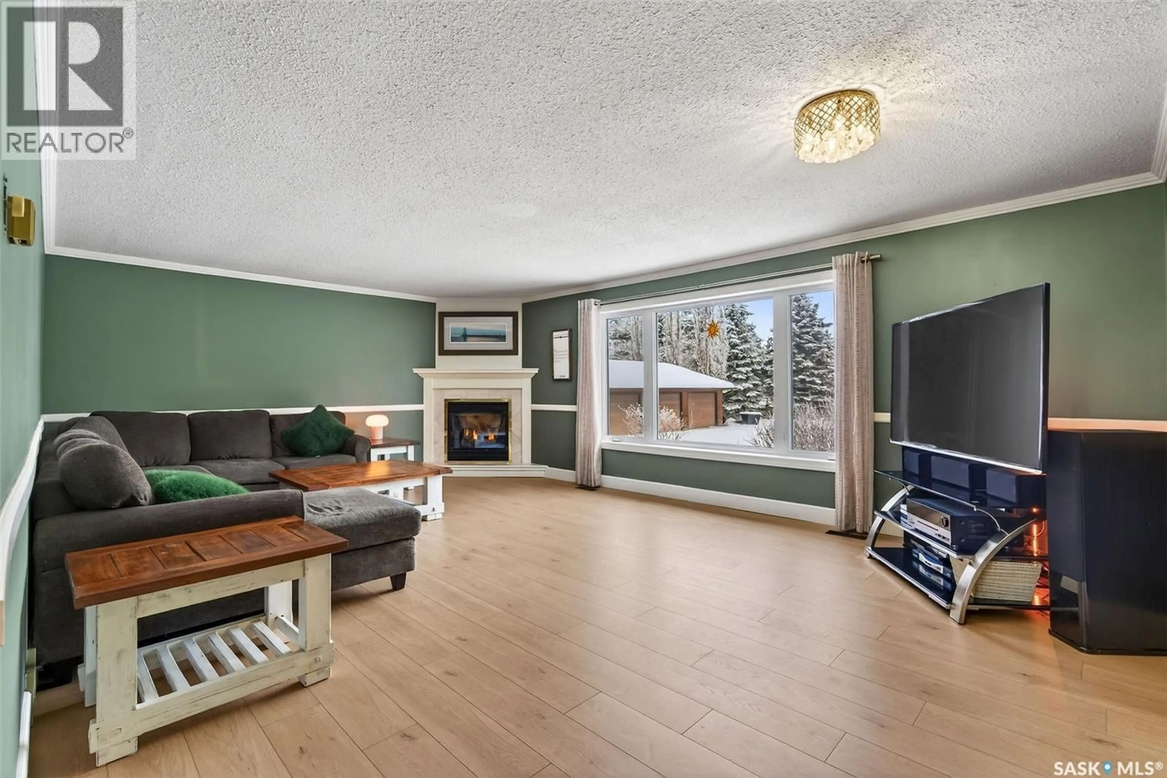 Living room with furniture, wood/laminate floor for 730 REID STREET, Buckland Rm No. 491 Saskatchewan S6V5R3