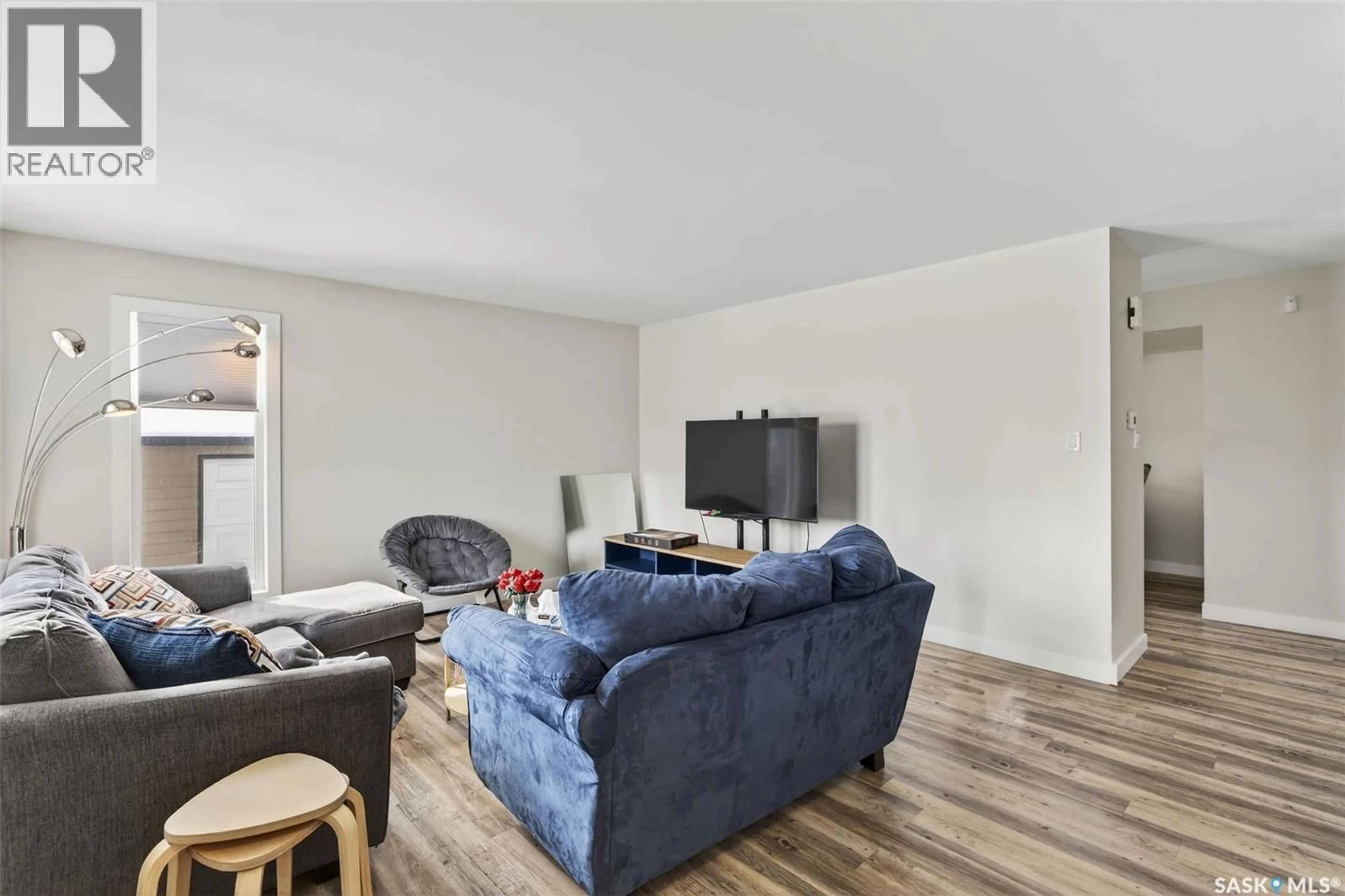 Living room with furniture, wood/laminate floor for 102-104 HEDLEY STREET, Saskatoon Saskatchewan S7N4G4