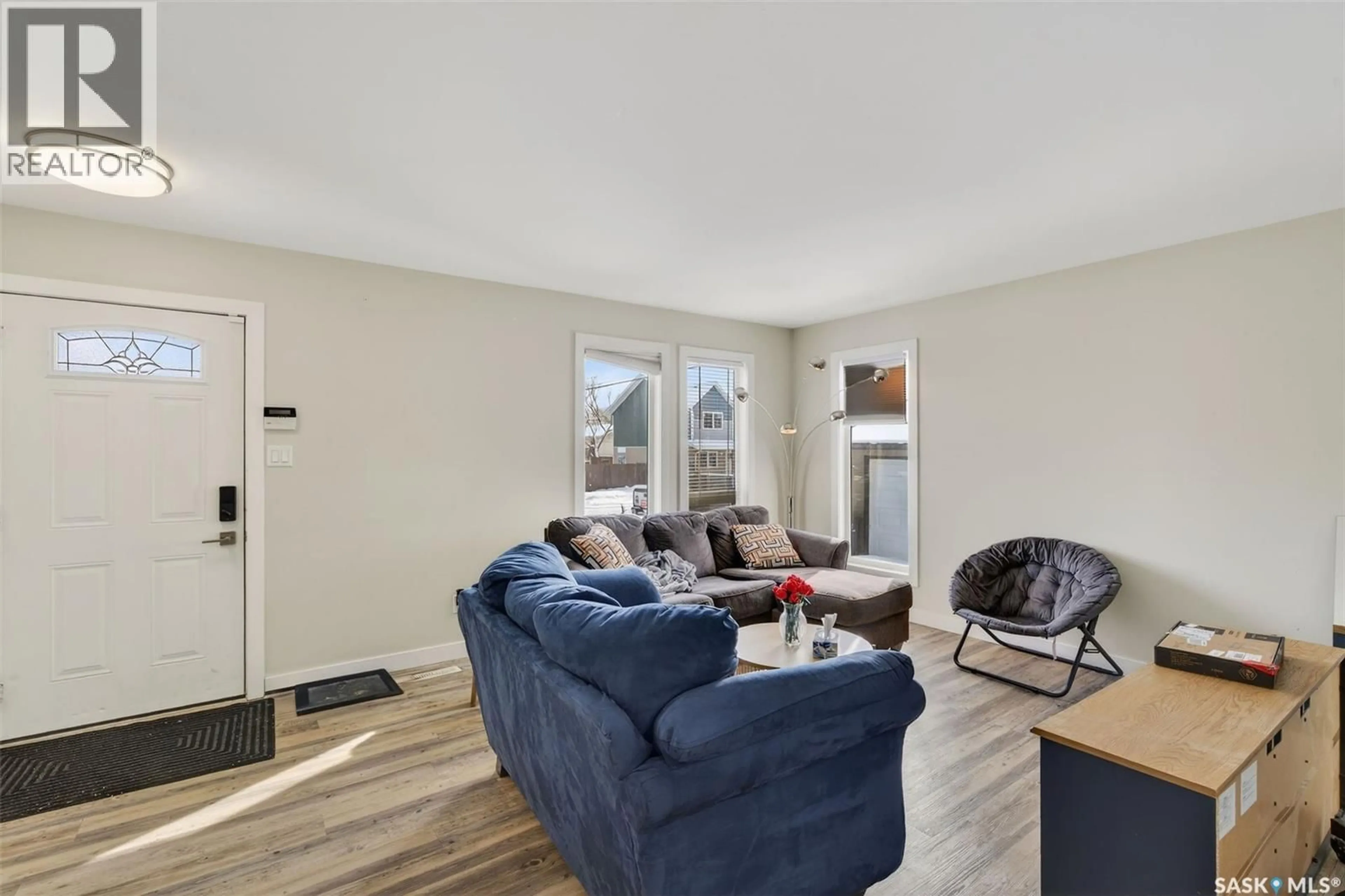 Living room with furniture, wood/laminate floor for 102-104 HEDLEY STREET, Saskatoon Saskatchewan S7N4G4